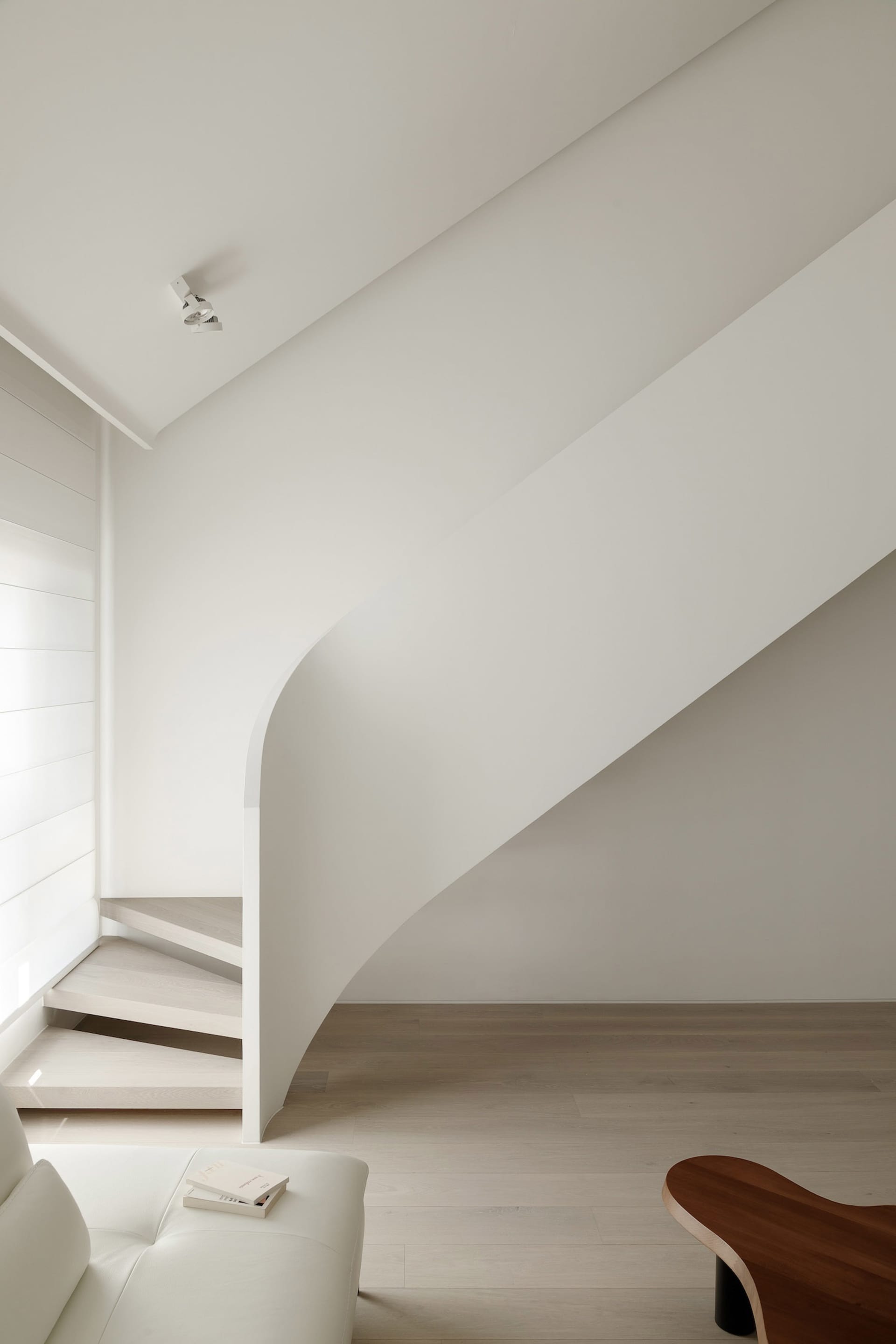 A minimalist staircase made of wood with clean lines and a smooth finish.