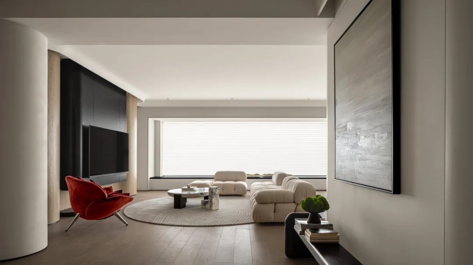 Modern living room with neutral tones, featuring a plush sofa and a sleek dining table with minimalist chairs.
