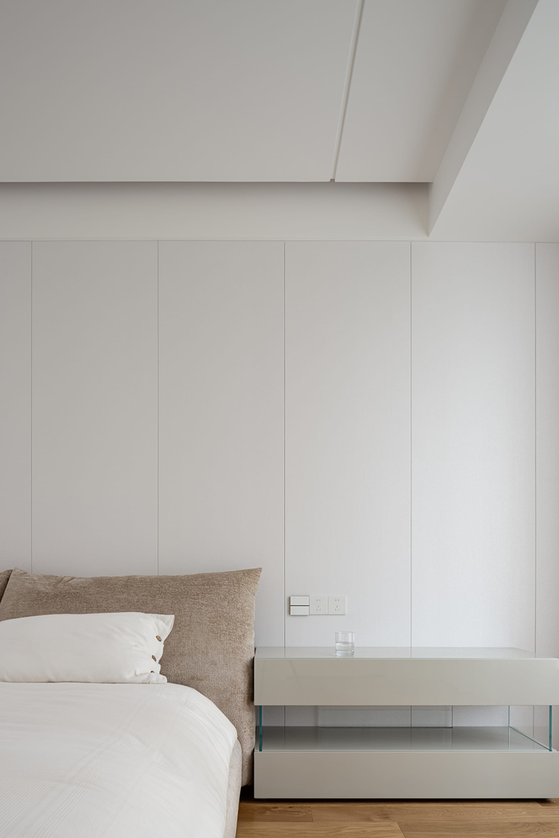 A modern, minimalist bedroom featuring neutral tones and clean lines, showcasing contemporary furniture design.