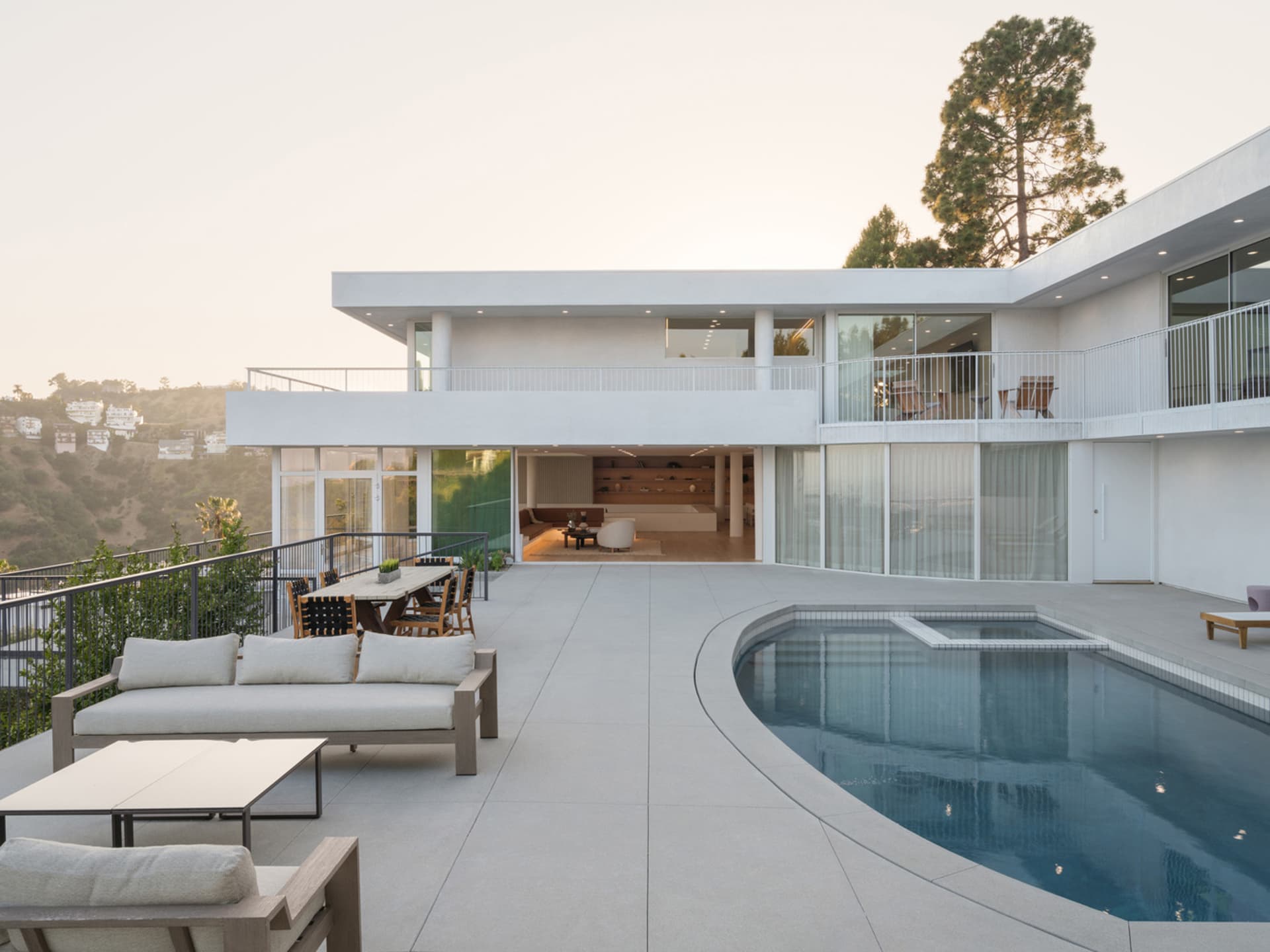 A modern residential building with a concrete exterior and a swimming pool.