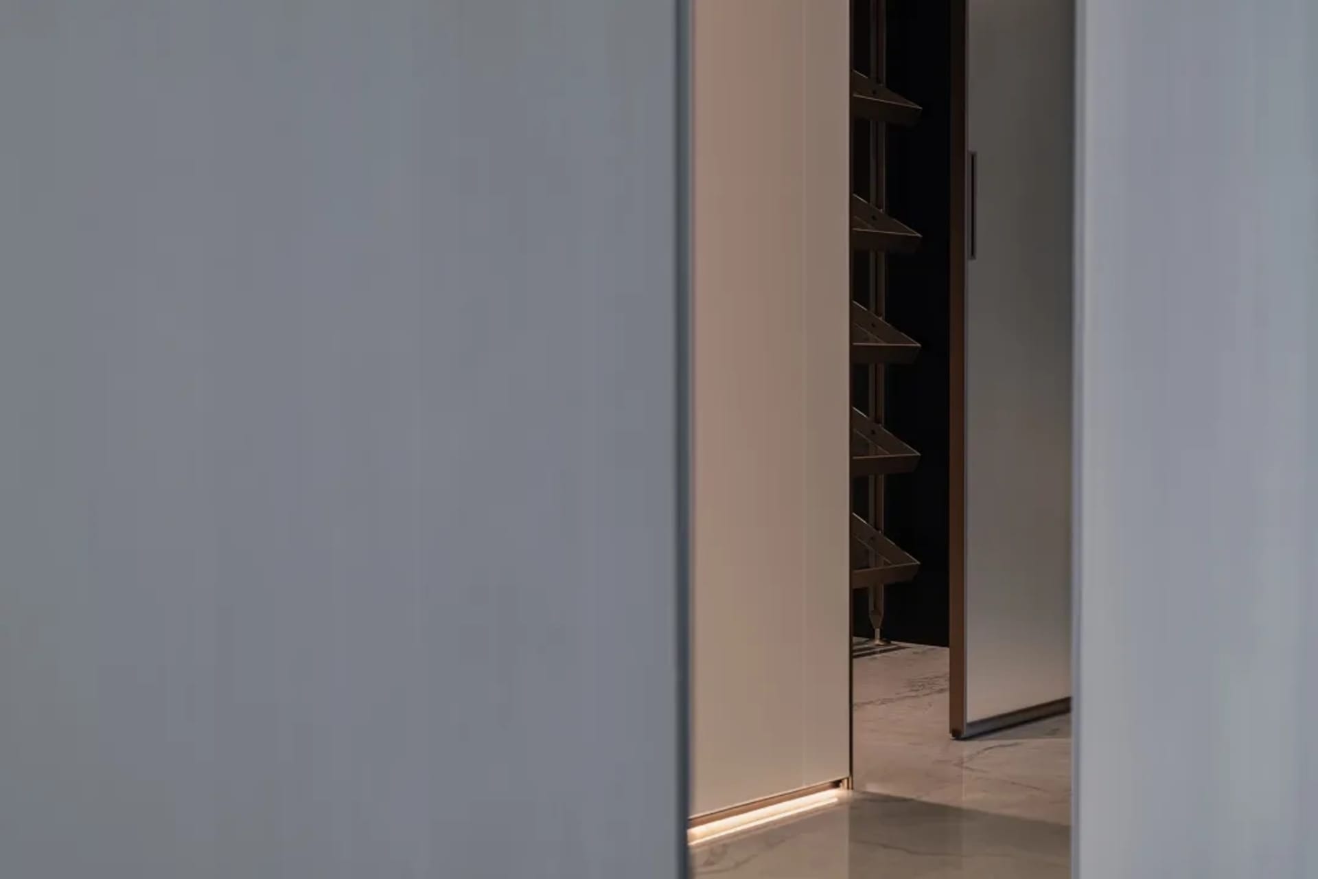 Modern, minimalist entry way with sleek metal floating shelves.