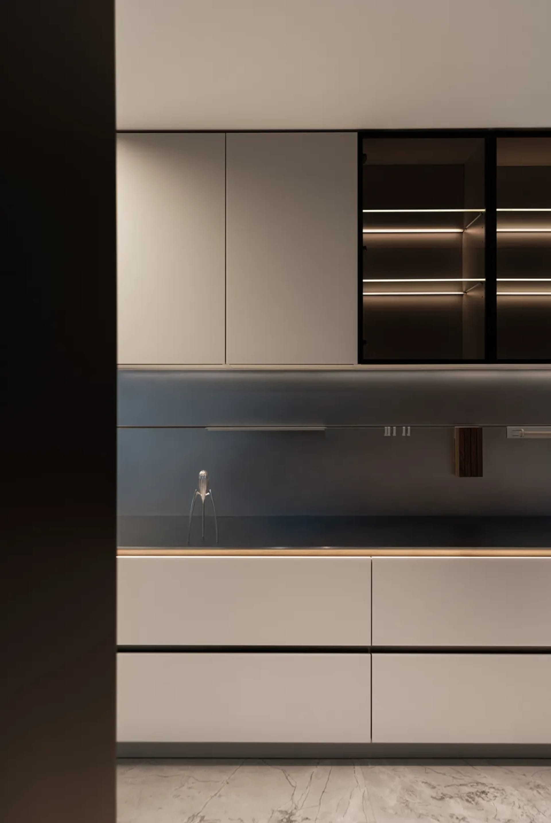 Modern, minimalist kitchen featuring metallic cabinets and sleek design elements.