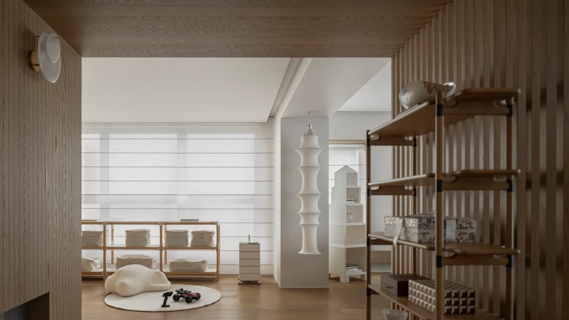 A minimalist living room featuring wooden shelves and fabric storage baskets.