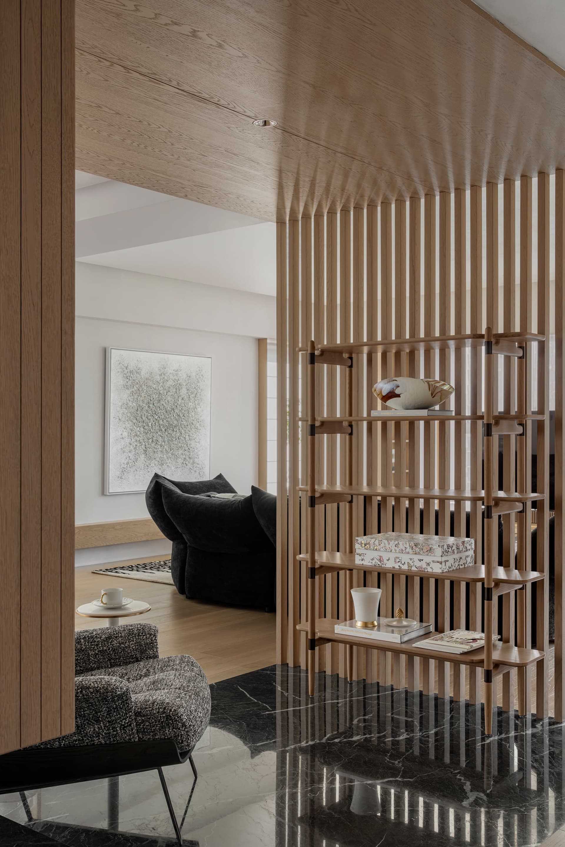 Modern living room interior featuring an elegant wooden divider with a minimalist design, featuring decorative items and a co