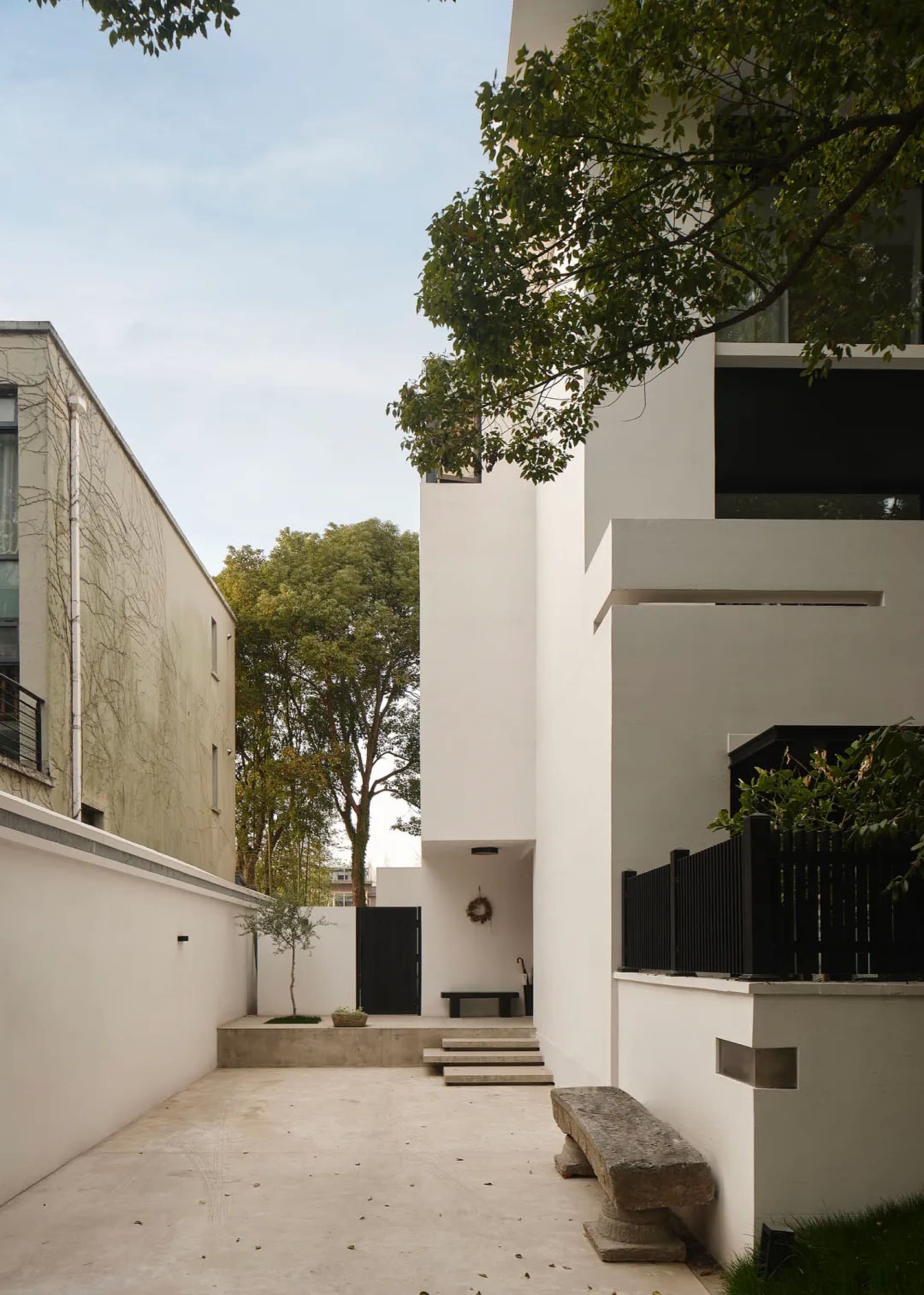 Modern residential exterior featuring concrete and glass materials, showcasing sleek, contemporary design.