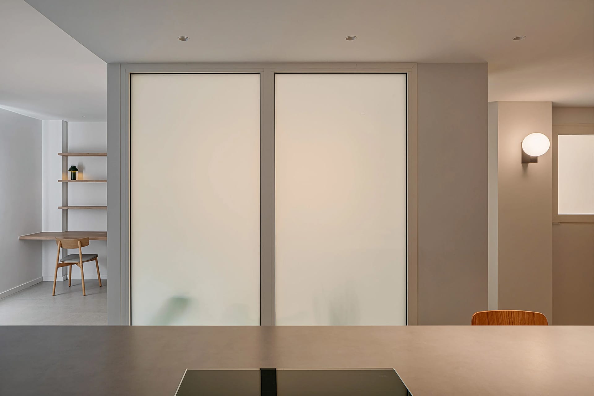 Minimalist modern kitchen with concrete flooring and walls.