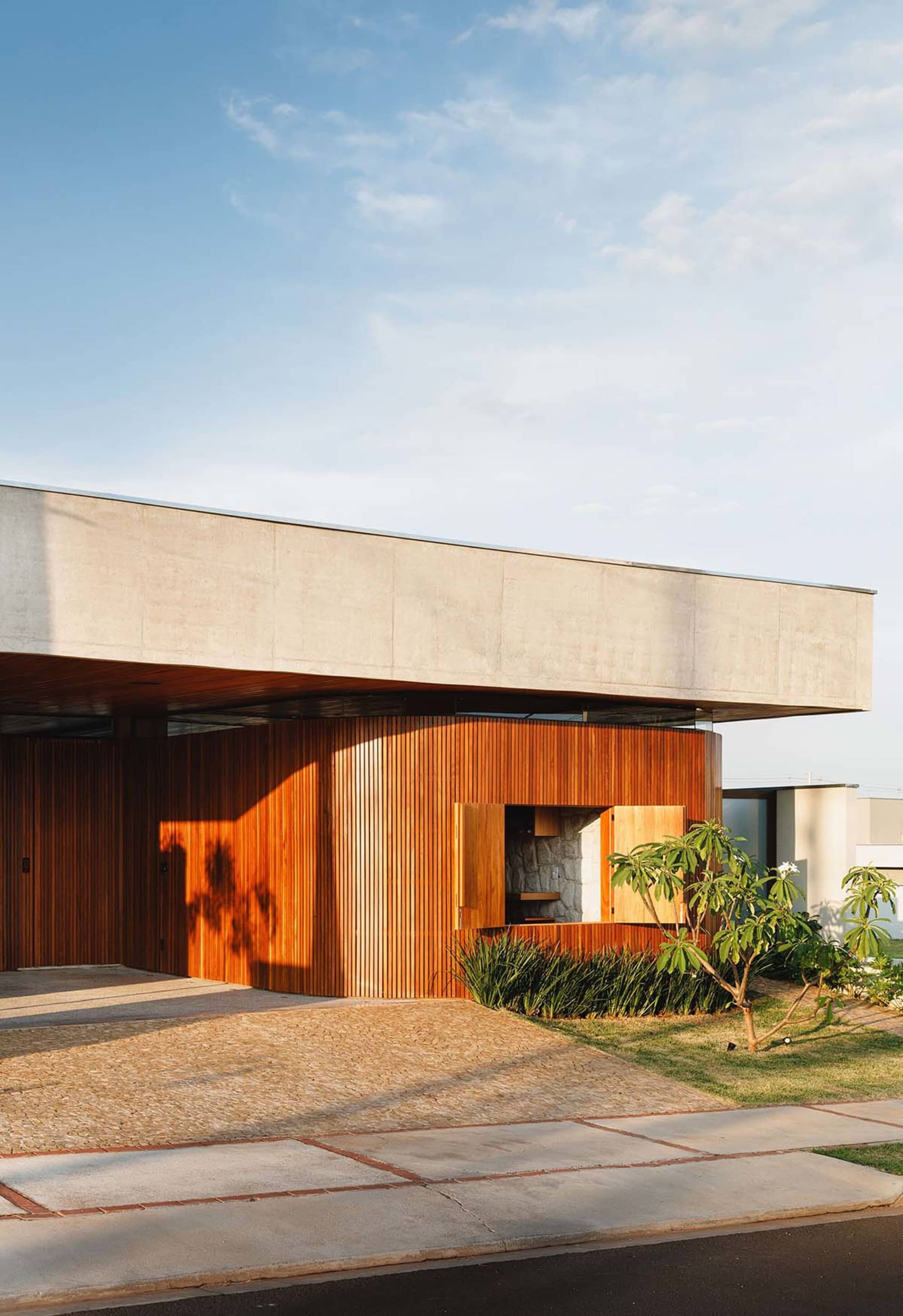 An architectural photo showcasing a modern building exterior with concrete and wood elements.