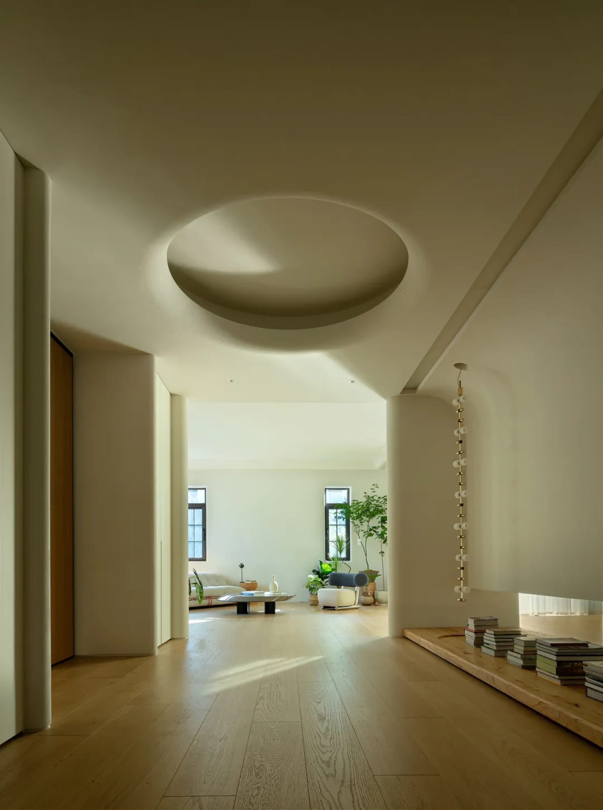 A modern living room with white walls and wooden flooring.