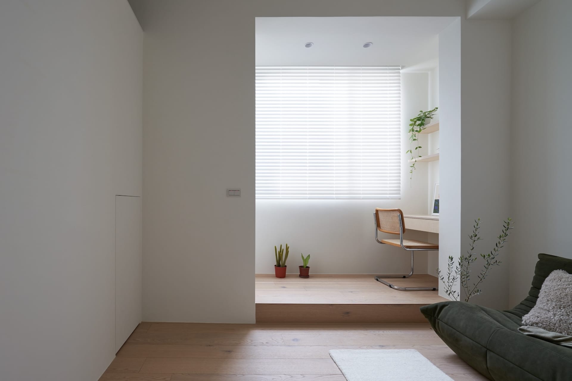 Minimalist office space featuring wood, glass, and metal materials.