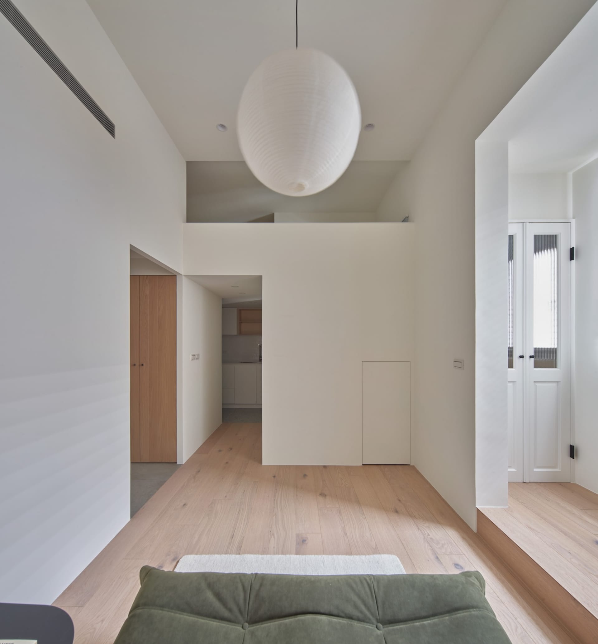 A modern living room with white walls and wooden floor.