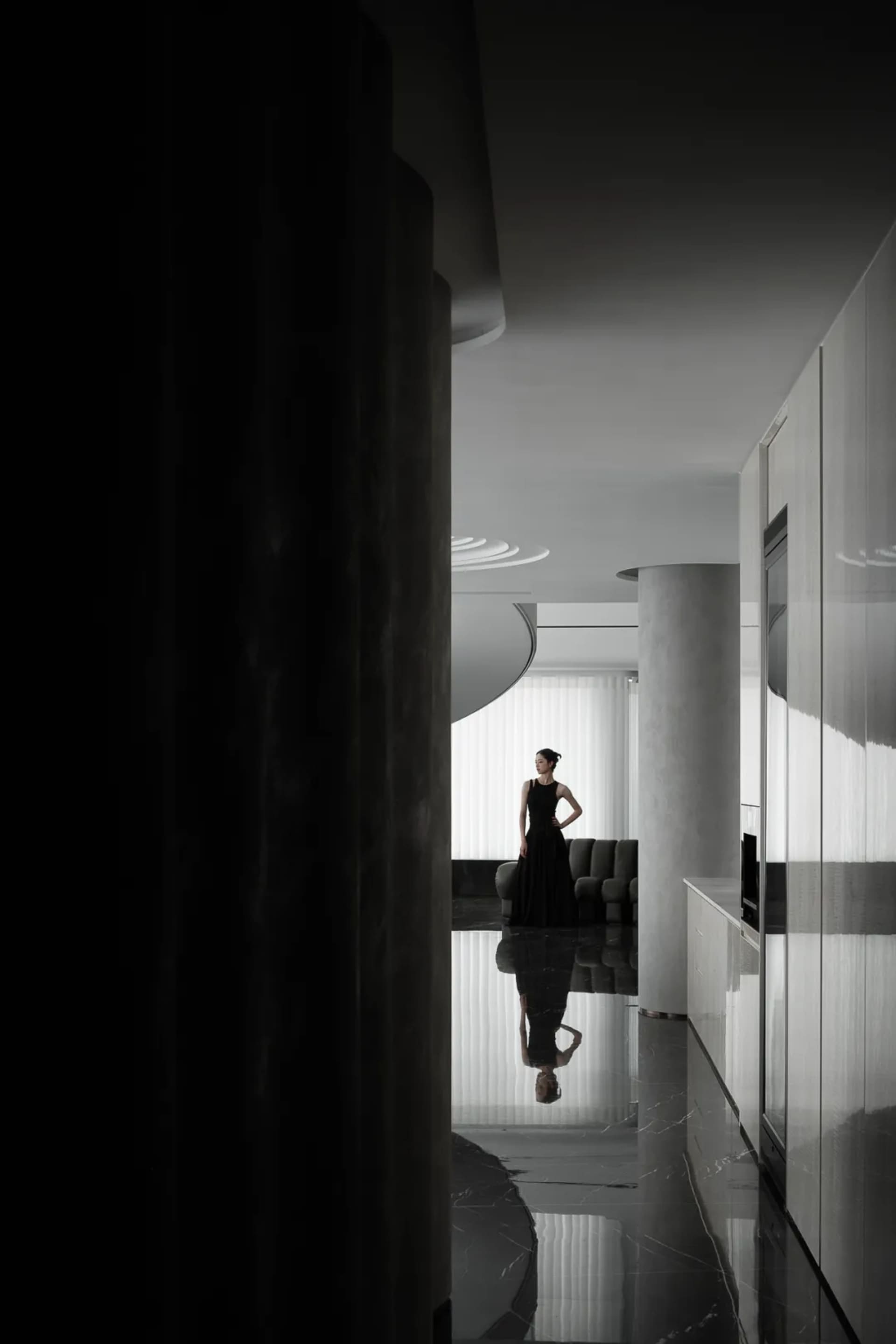 A modern apartment with glass walls and marble finishes.