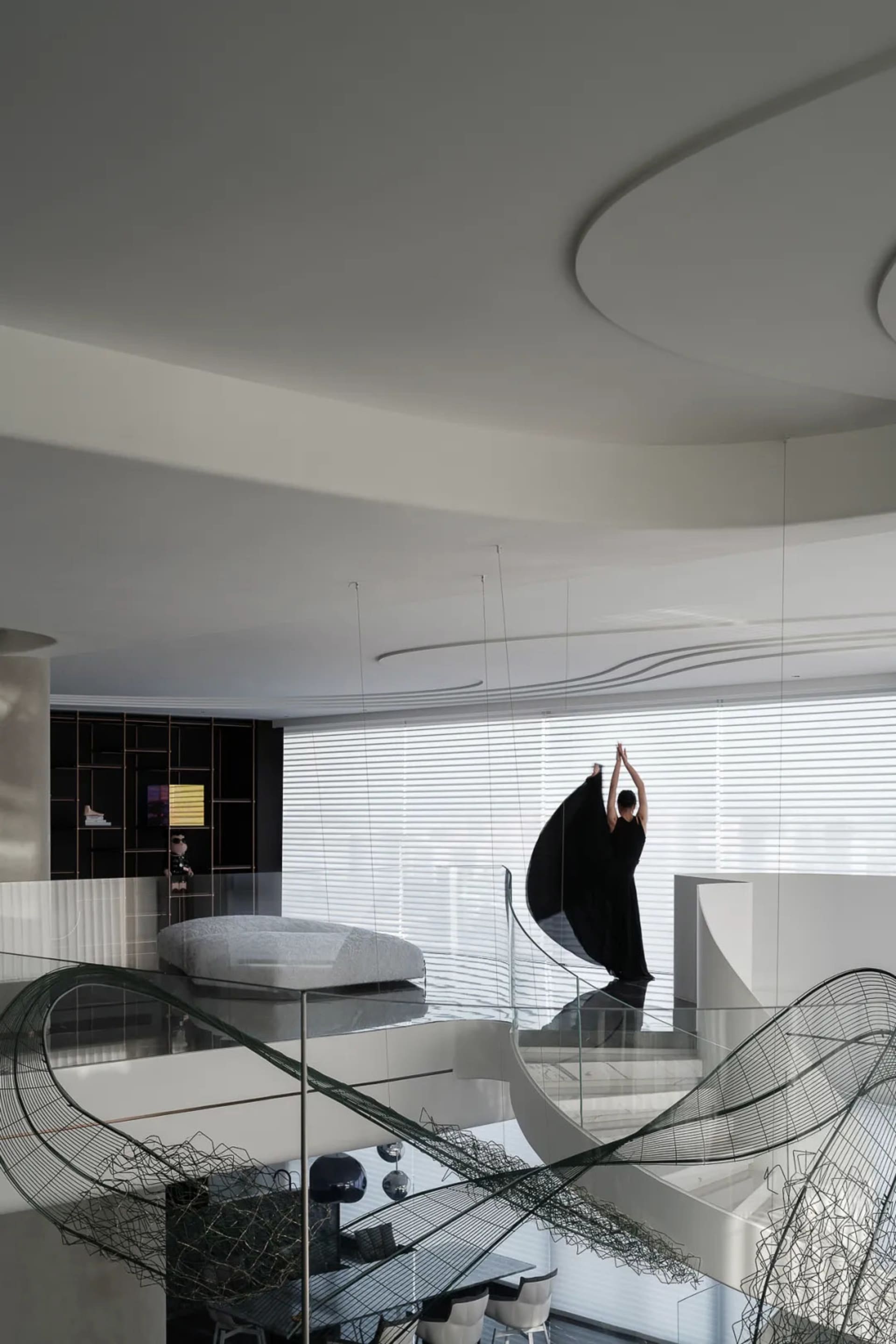 A modern living room featuring a glass balustrade