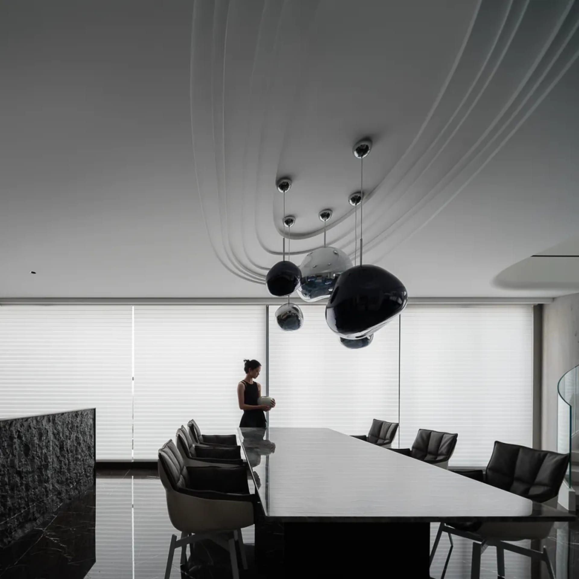 A modern, minimalist office space featuring glass, concrete, and steel elements.
