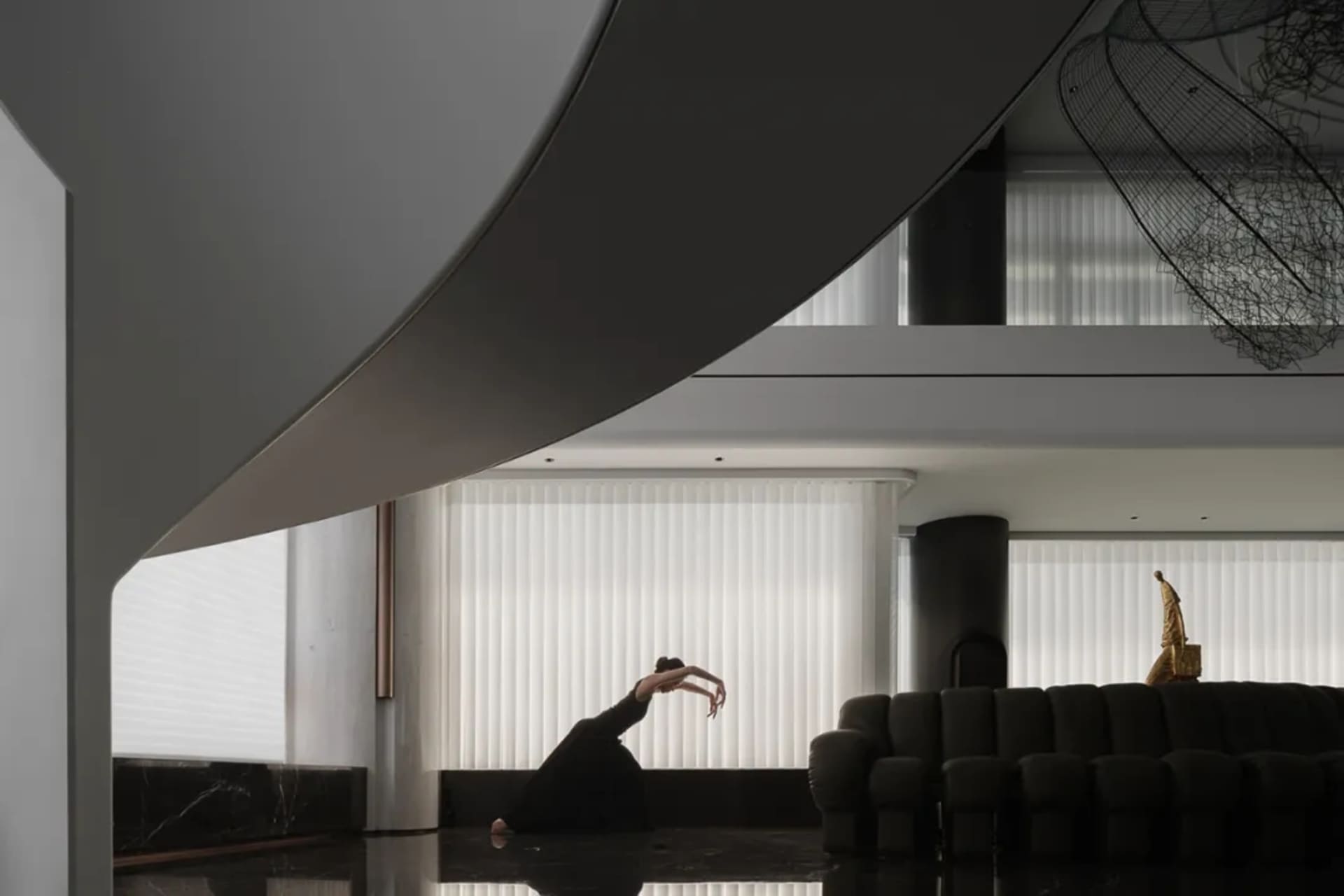 A modern living room with metal, glass, and concrete materials