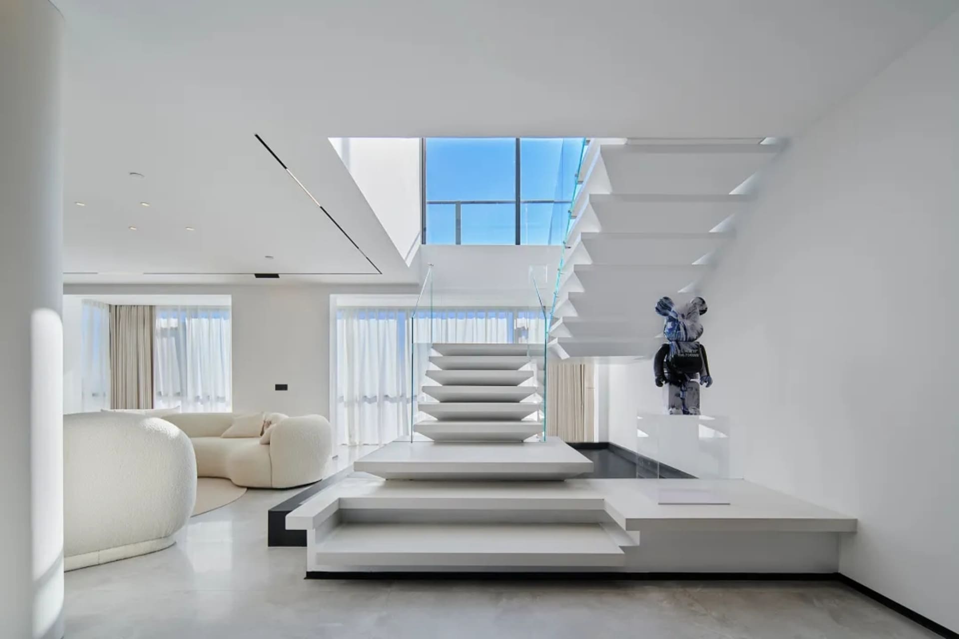 Modern interior design featuring a living room with a glass staircase.