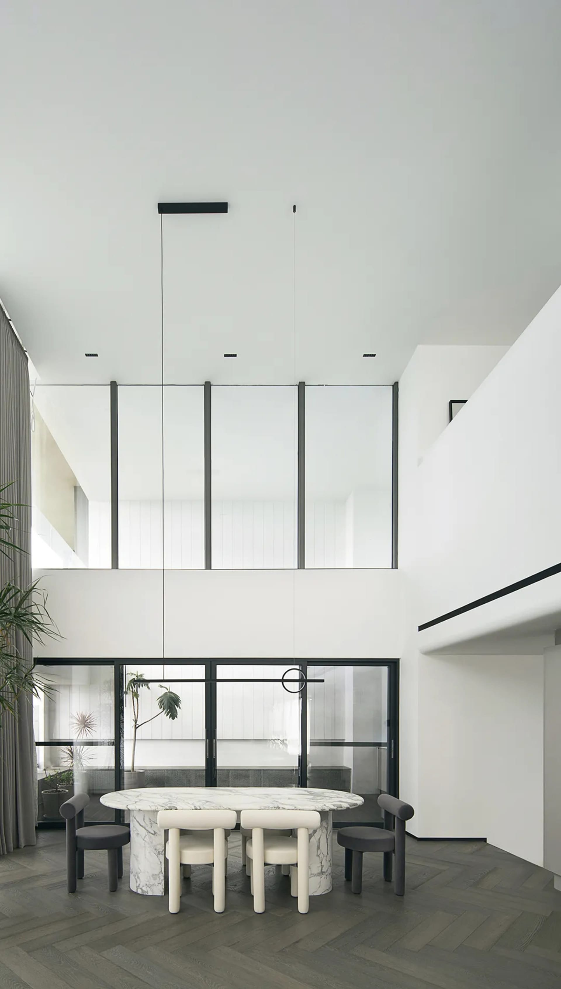 Modern dining room with a marble table and minimalist design.