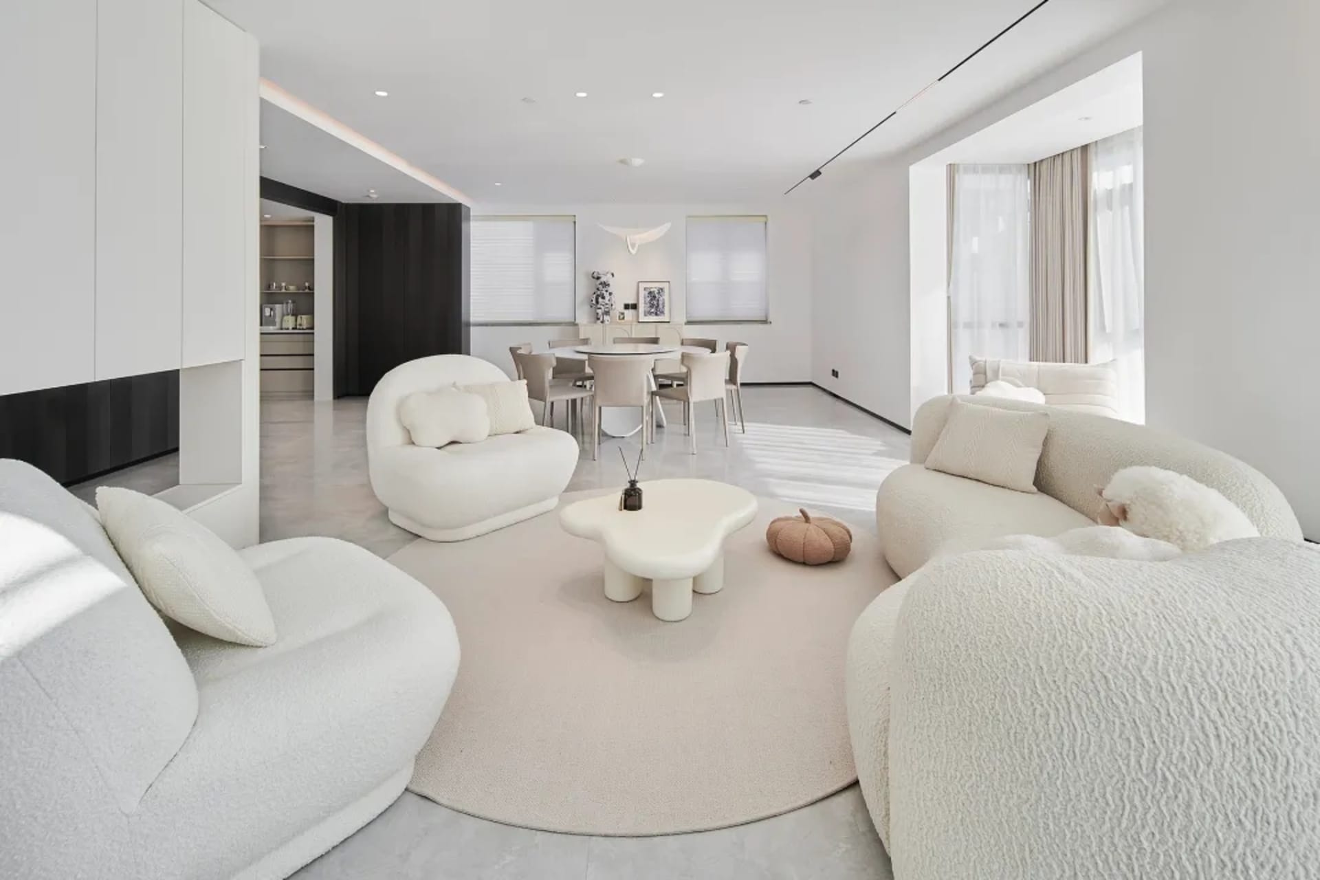 A modern living room with neutral-toned furniture and a minimalist aesthetic.
