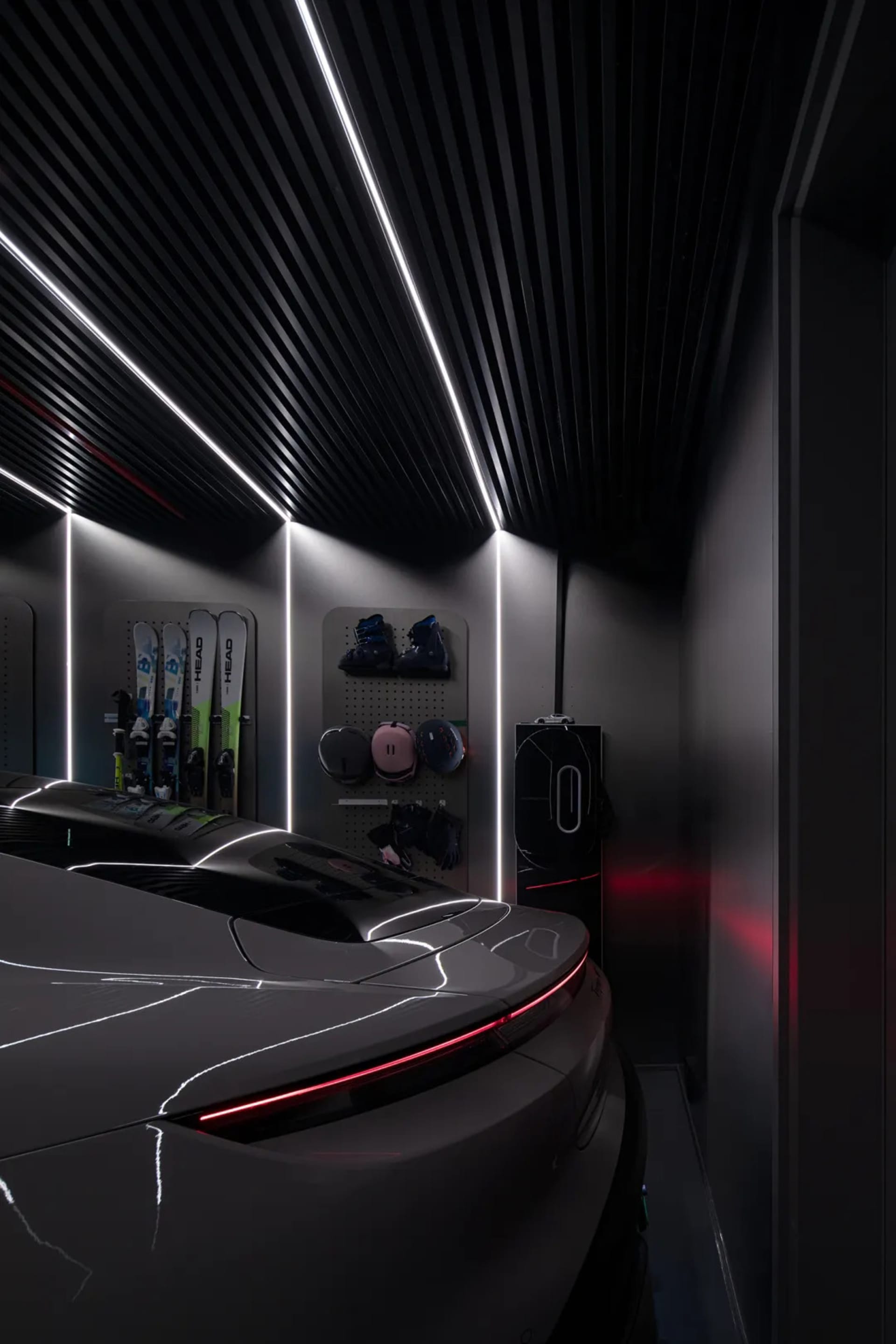 A sleek, modern garage interior with black metal walls and ceiling features.