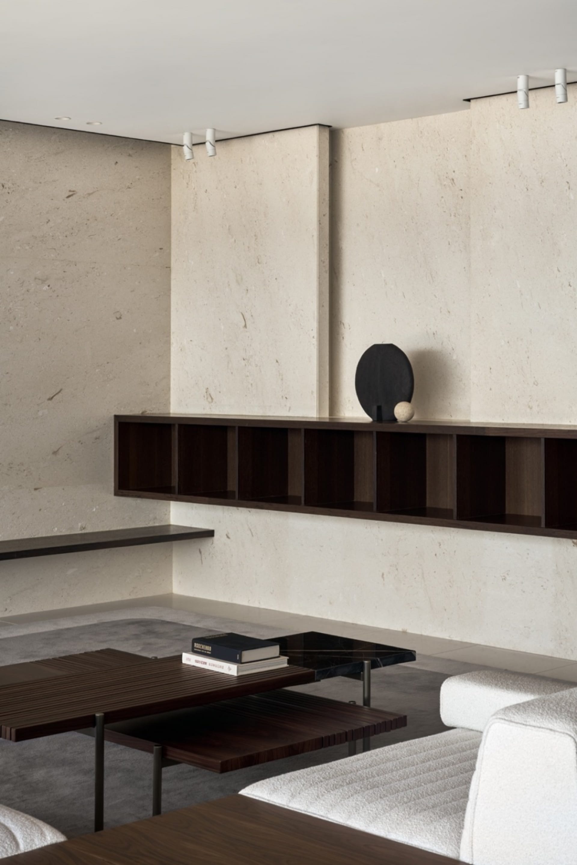Minimalist living room featuring a concrete structure with modern furniture and decor.
