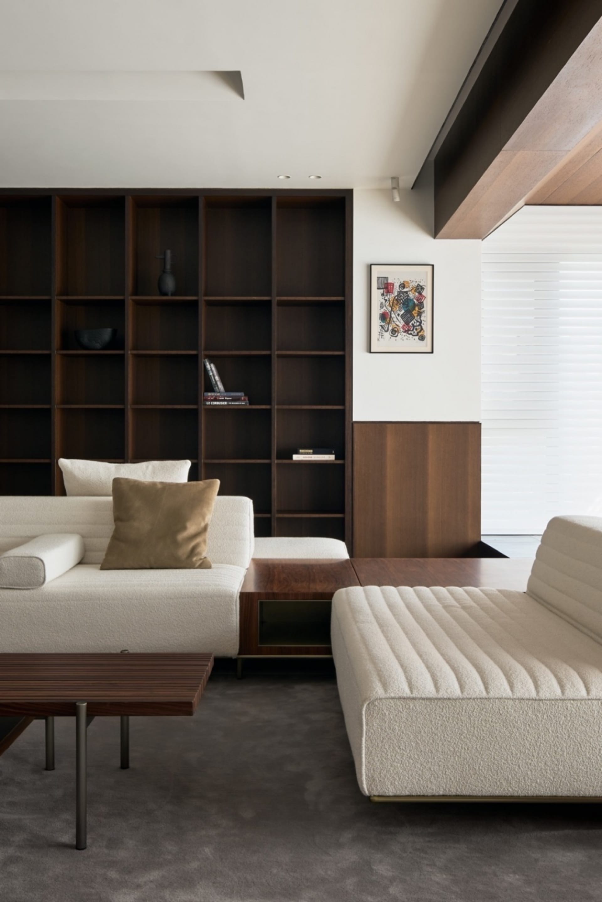 Modern living room featuring wooden furniture and a large bookshelf.