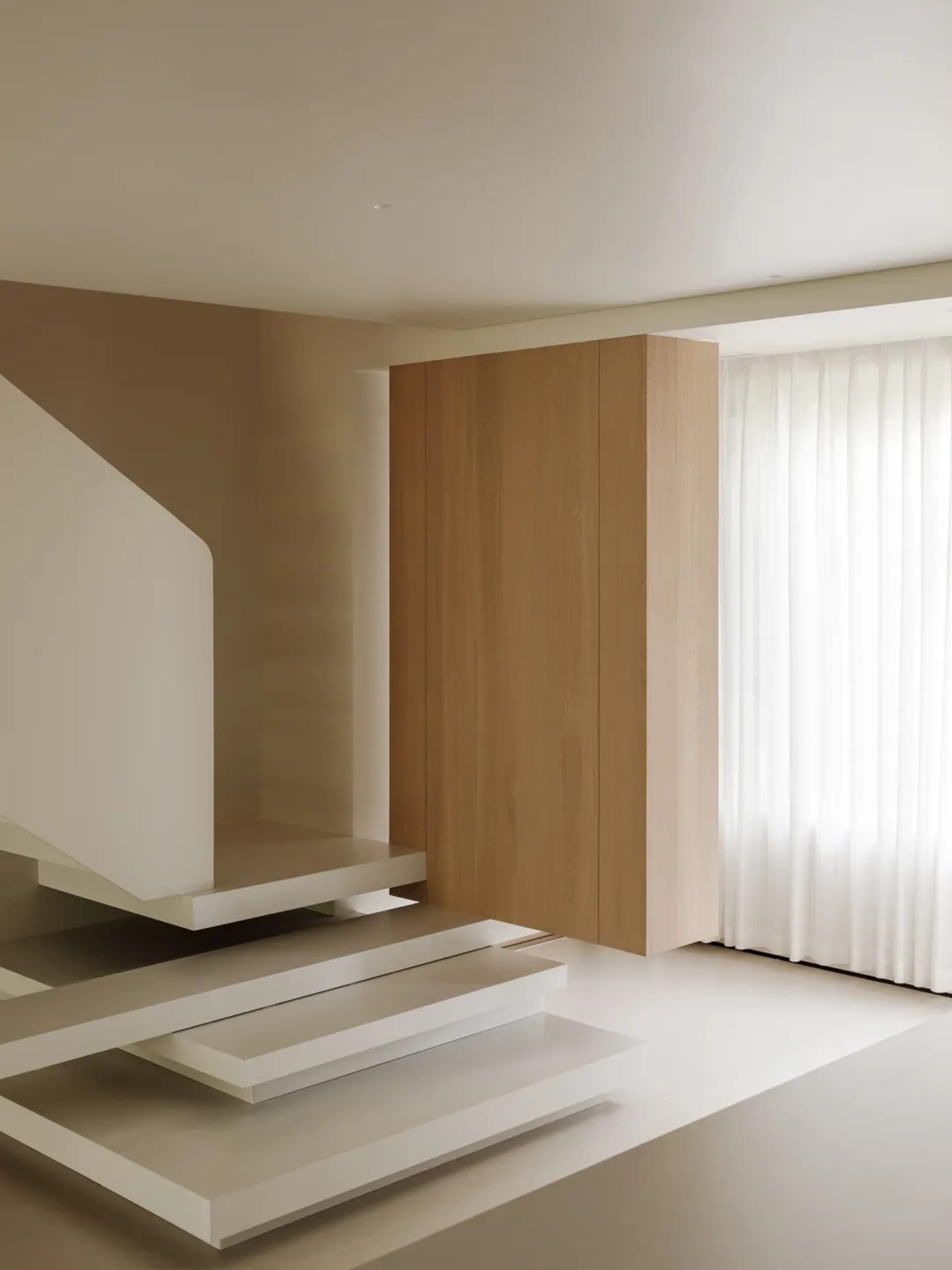 Modern, minimalist staircase with concrete steps and railings.