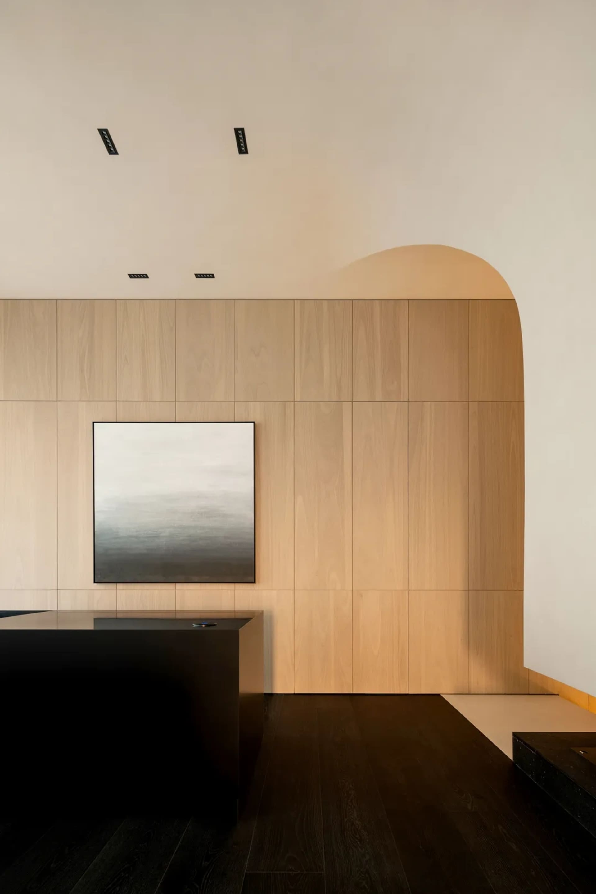 A minimalist interior featuring wooden panels.