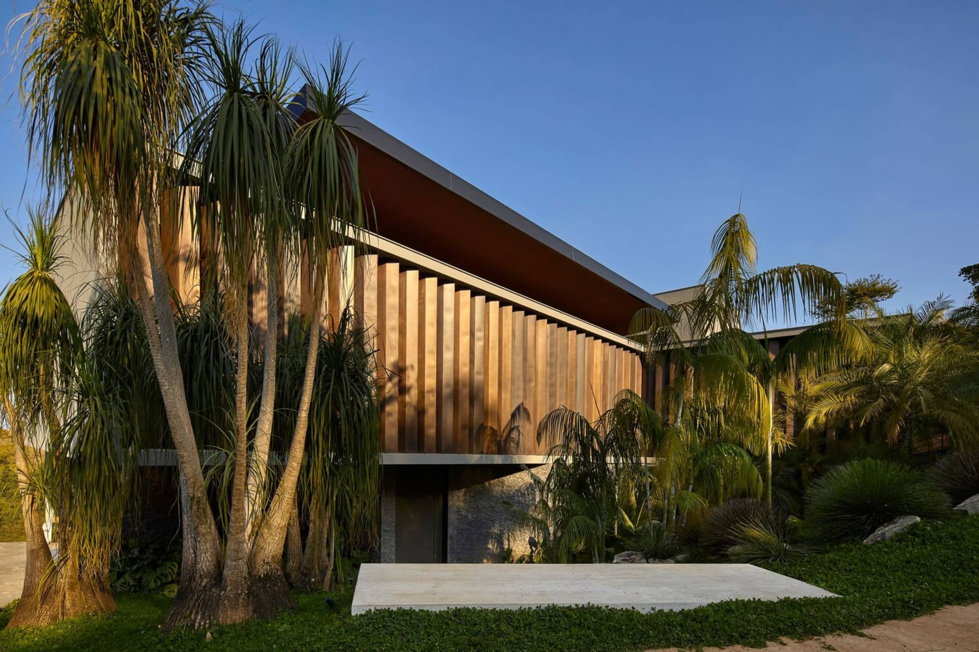 A modern architectural design featuring wooden exterior materials.
