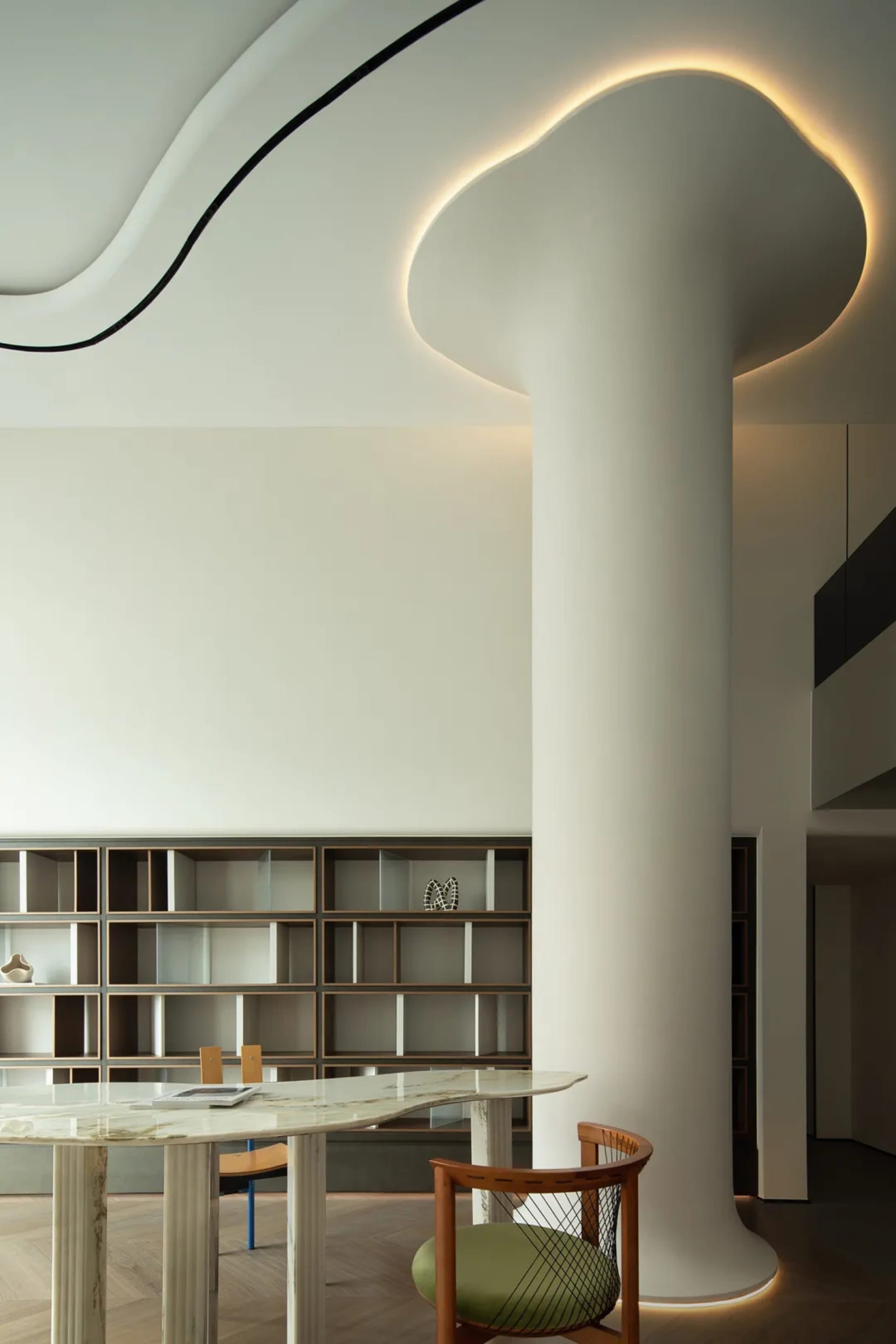 A modern library space featuring white concrete columns, clean lines, and minimalist design.