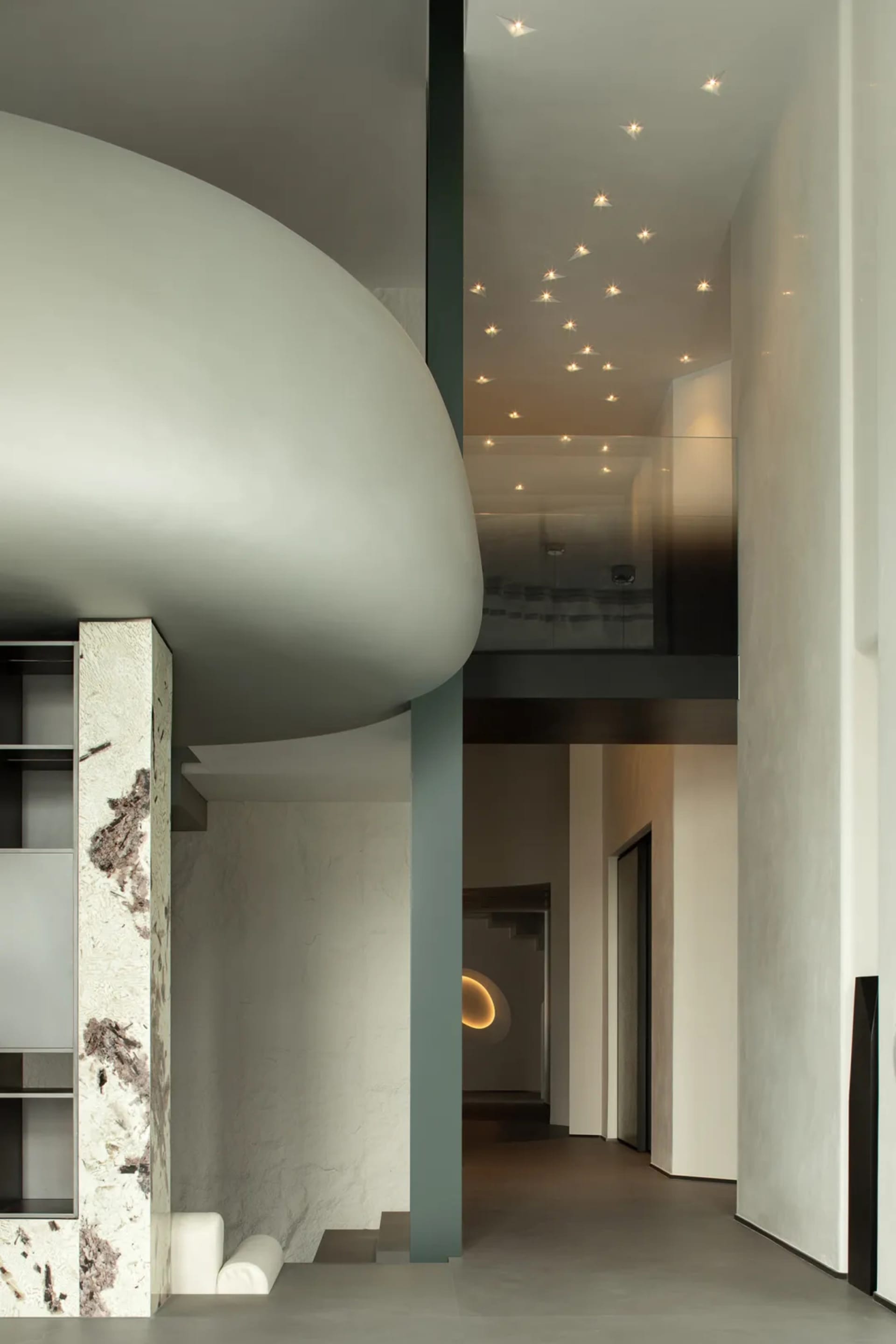 Modern minimalist entrance hall with concrete walls and ceiling lights
