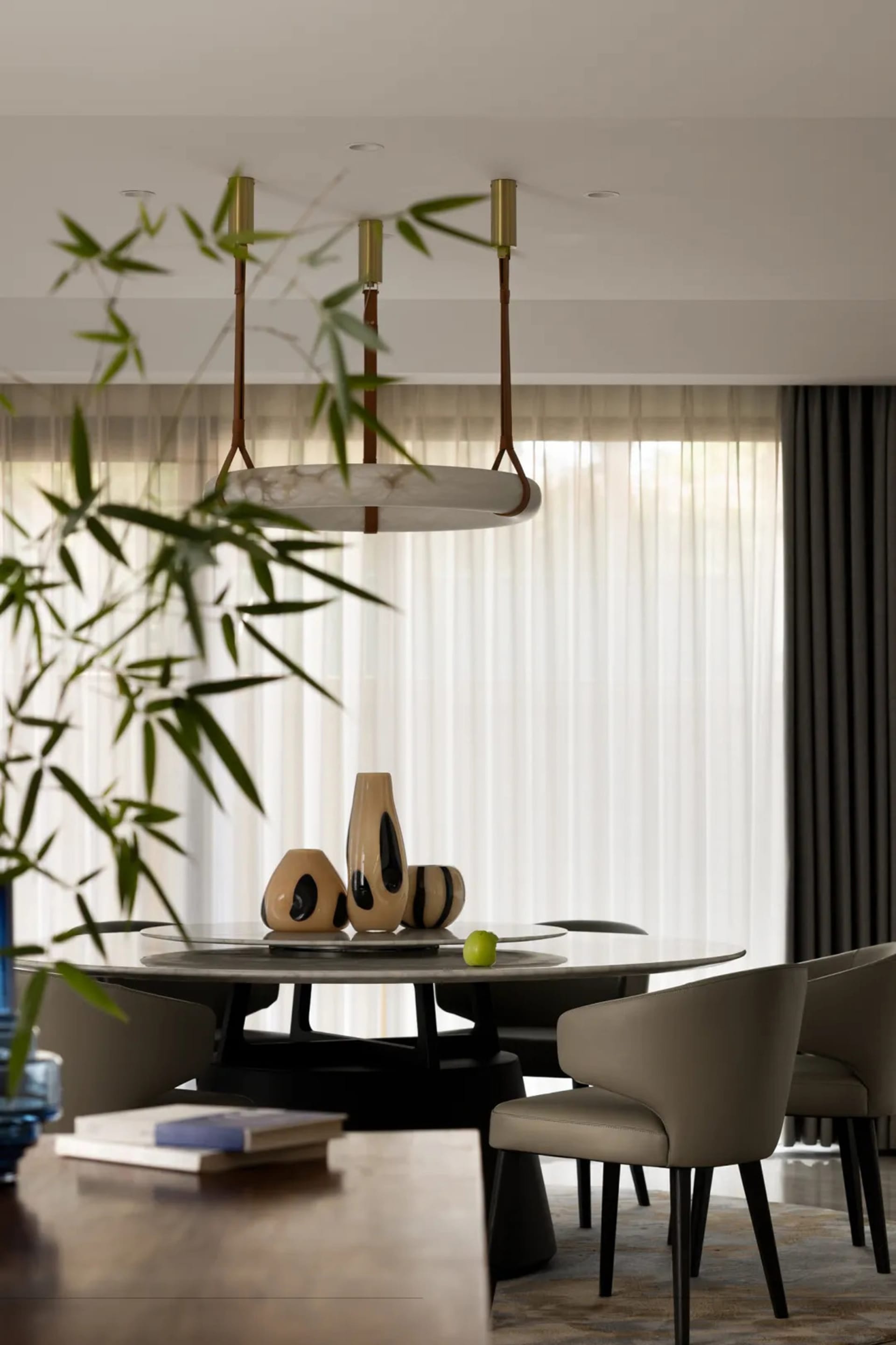 Modern dining room with stylish glass table and leather chairs.