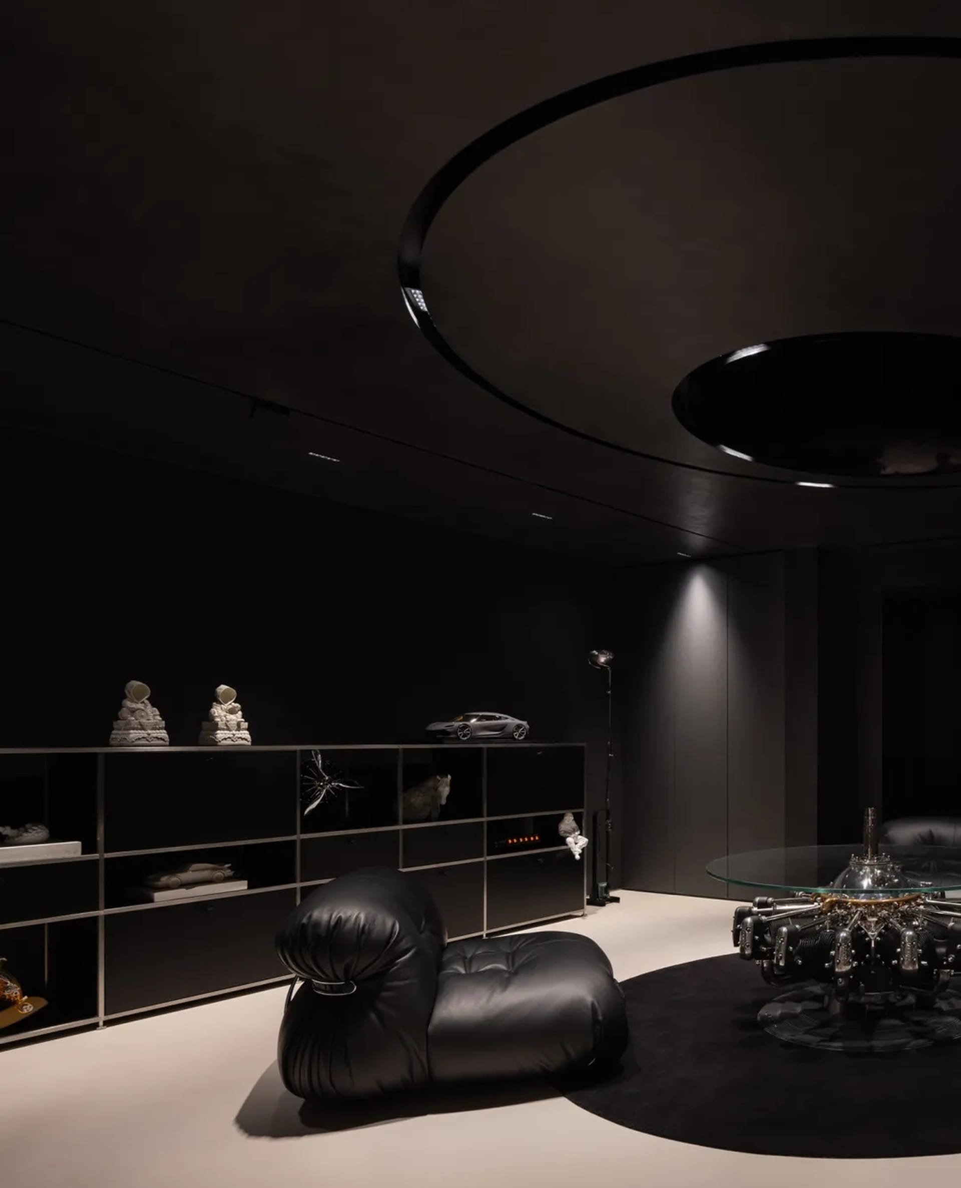 Modern living room featuring sleek, black metallic furniture and minimalistic decor.