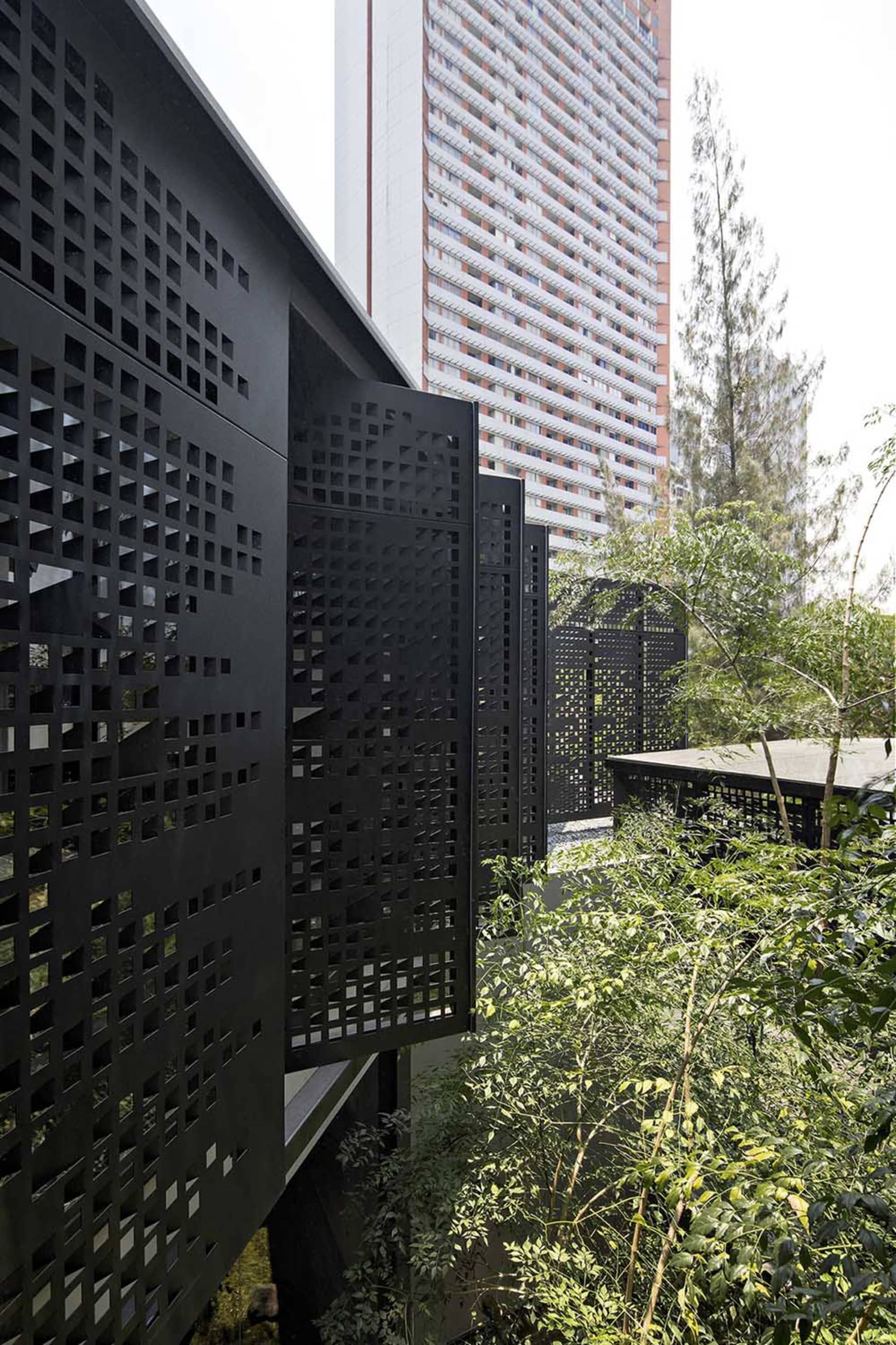 Urban rooftop with modern black perforated metal grid for greenery