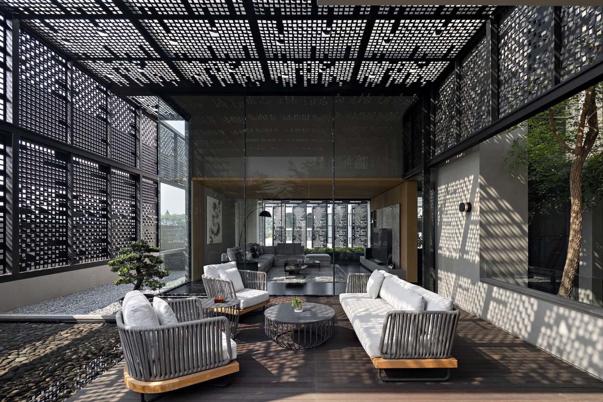 A modern living room with concrete and glass walls and furnishings.