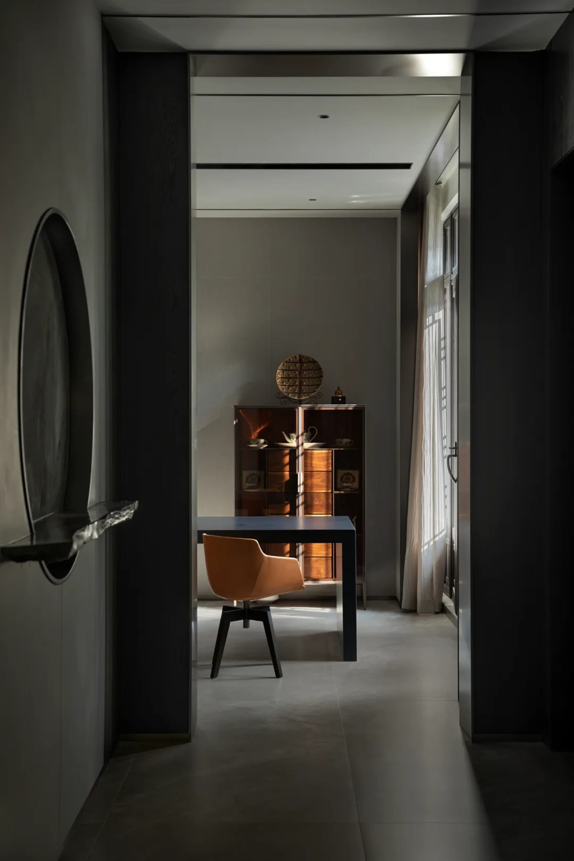 Modern home office with metallic finishes, featuring a sleek desk and minimalist chair.