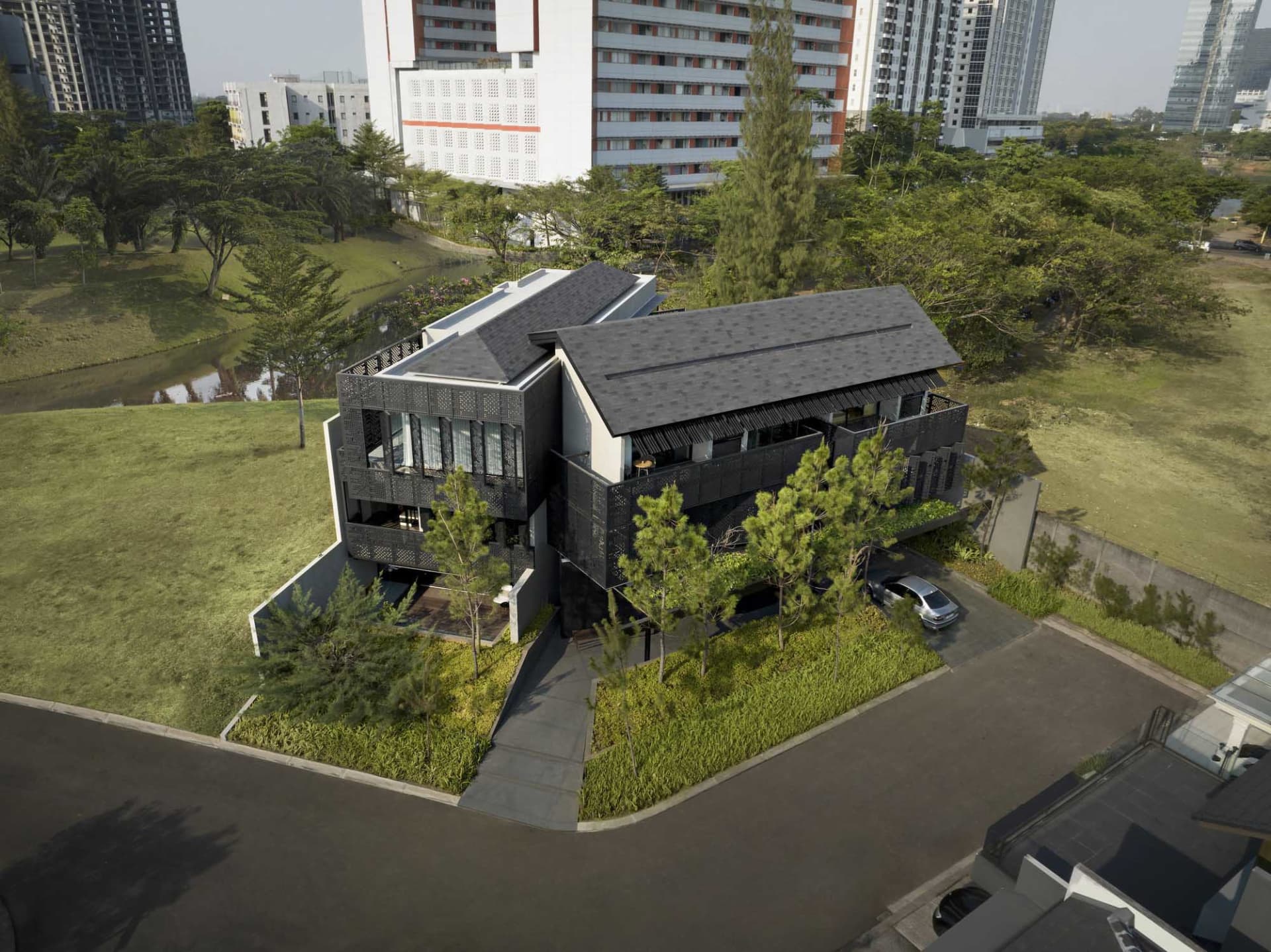 A modern building with a metal facade and black windows and railings.