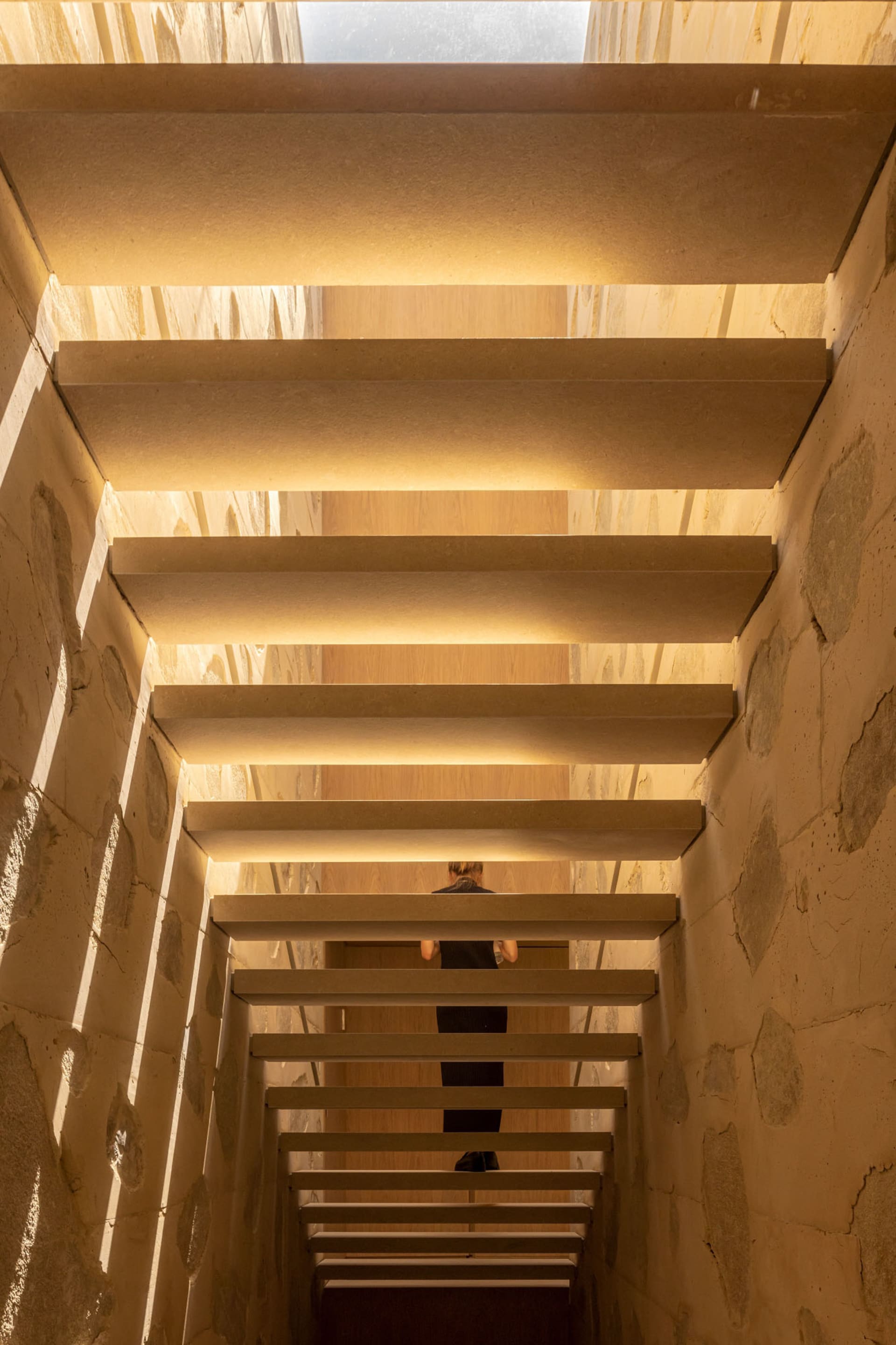 A modern interior space with a staircase made of concrete.