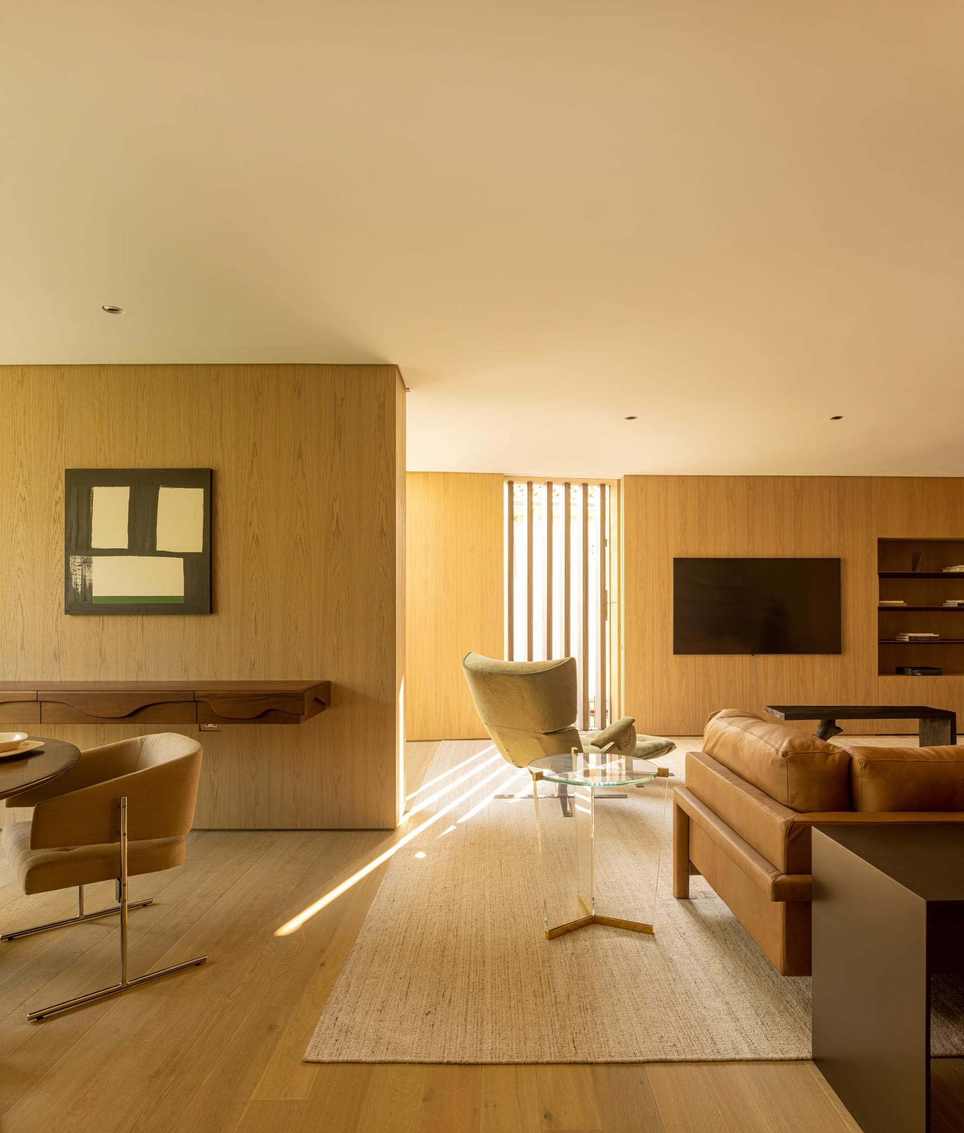 Modern living room with wooden walls and minimalist design.