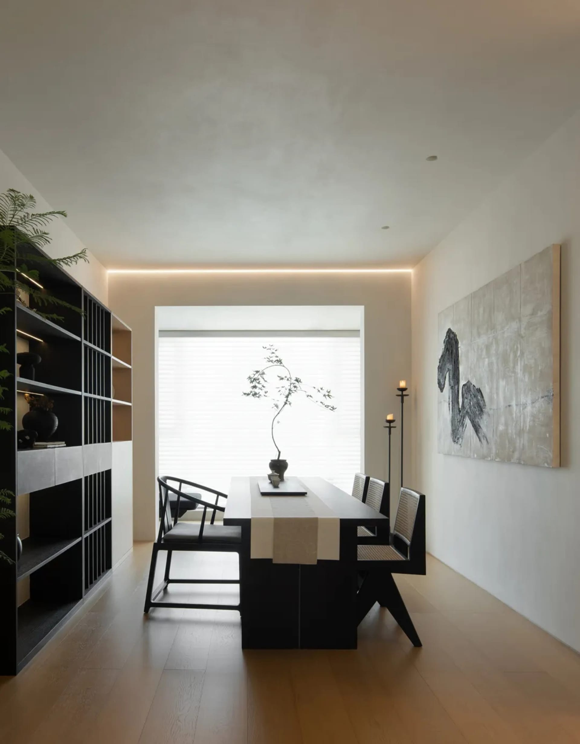 Modern living room with timber, metal, and glass furniture, minimalist decor, and large windows.