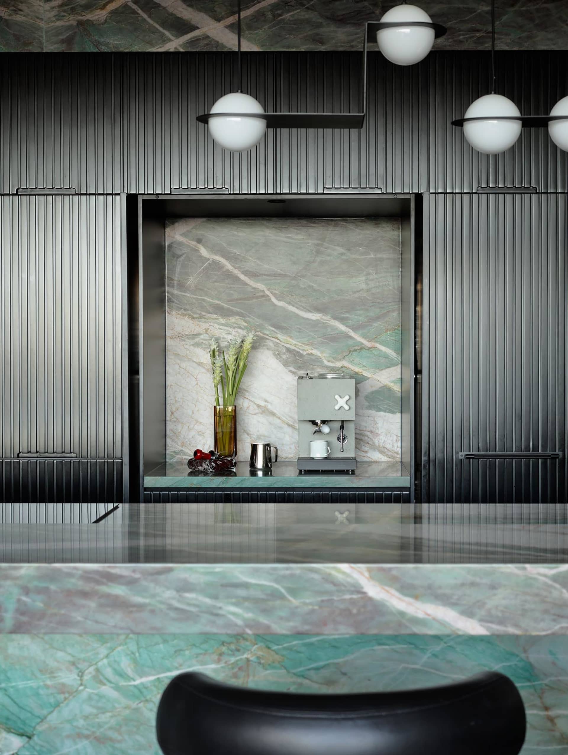Modern kitchen with a marble counter and minimalist design.