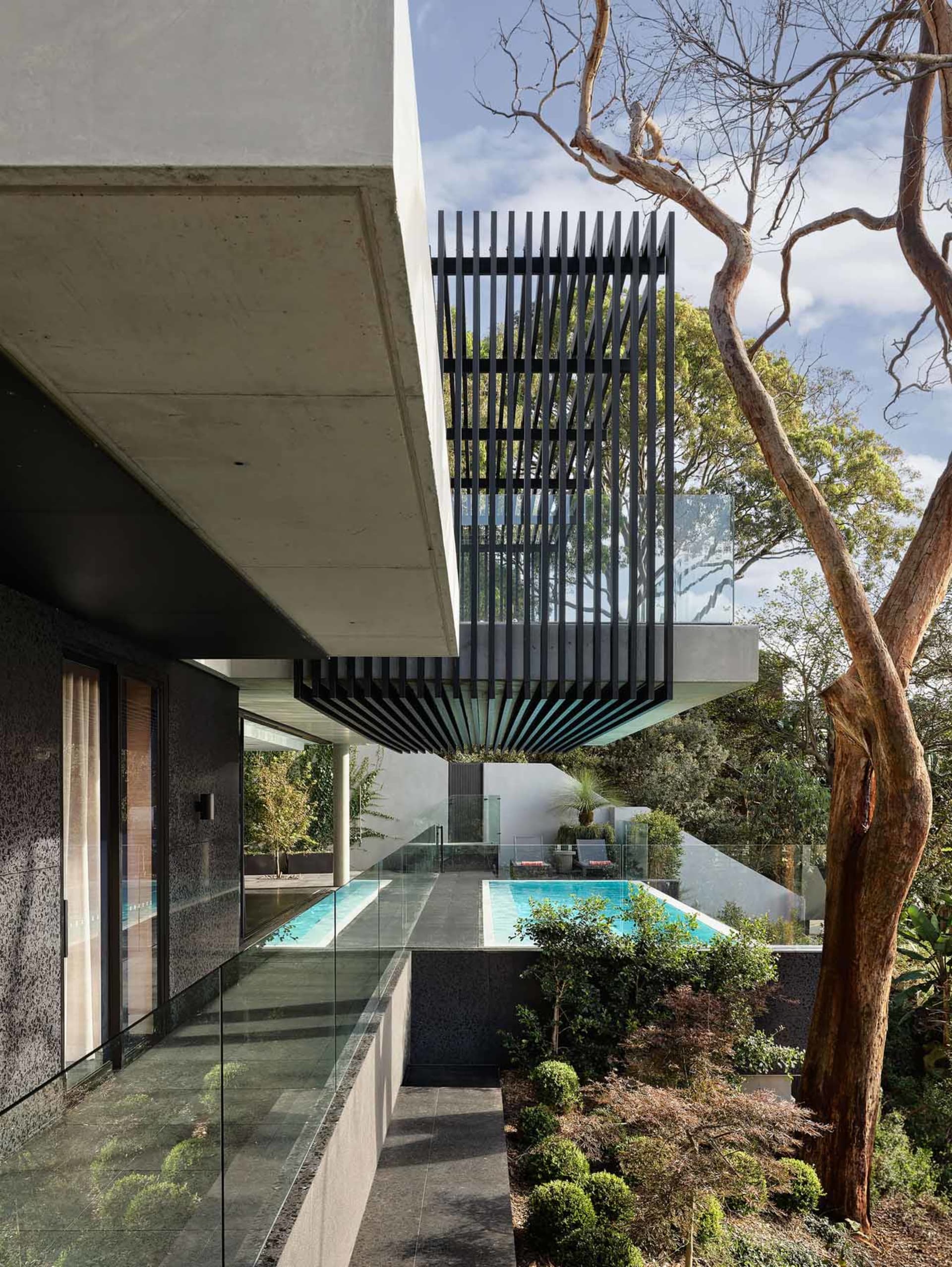 Outdoor contemporary residential area showcasing modern minimalist architecture with concrete and glass materials.