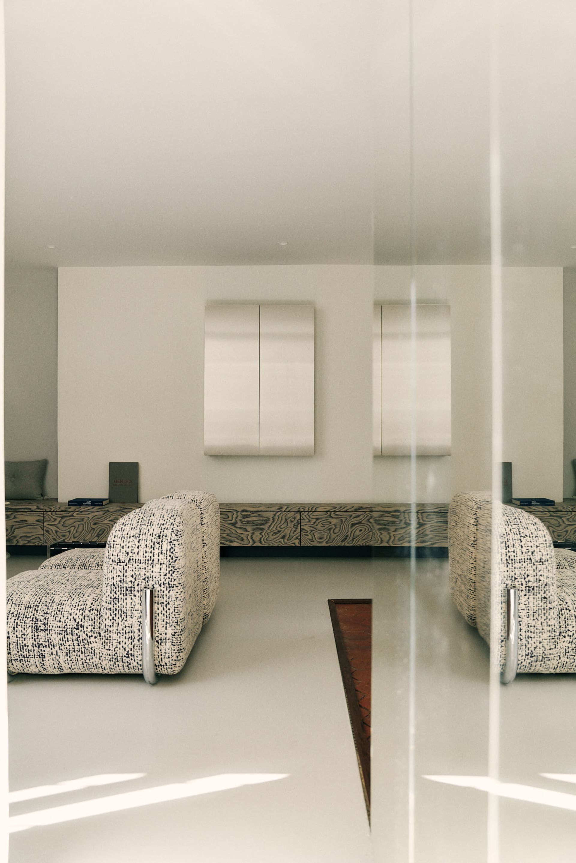 Minimalist living room with neutral furnishings and a minimalist aesthetic.