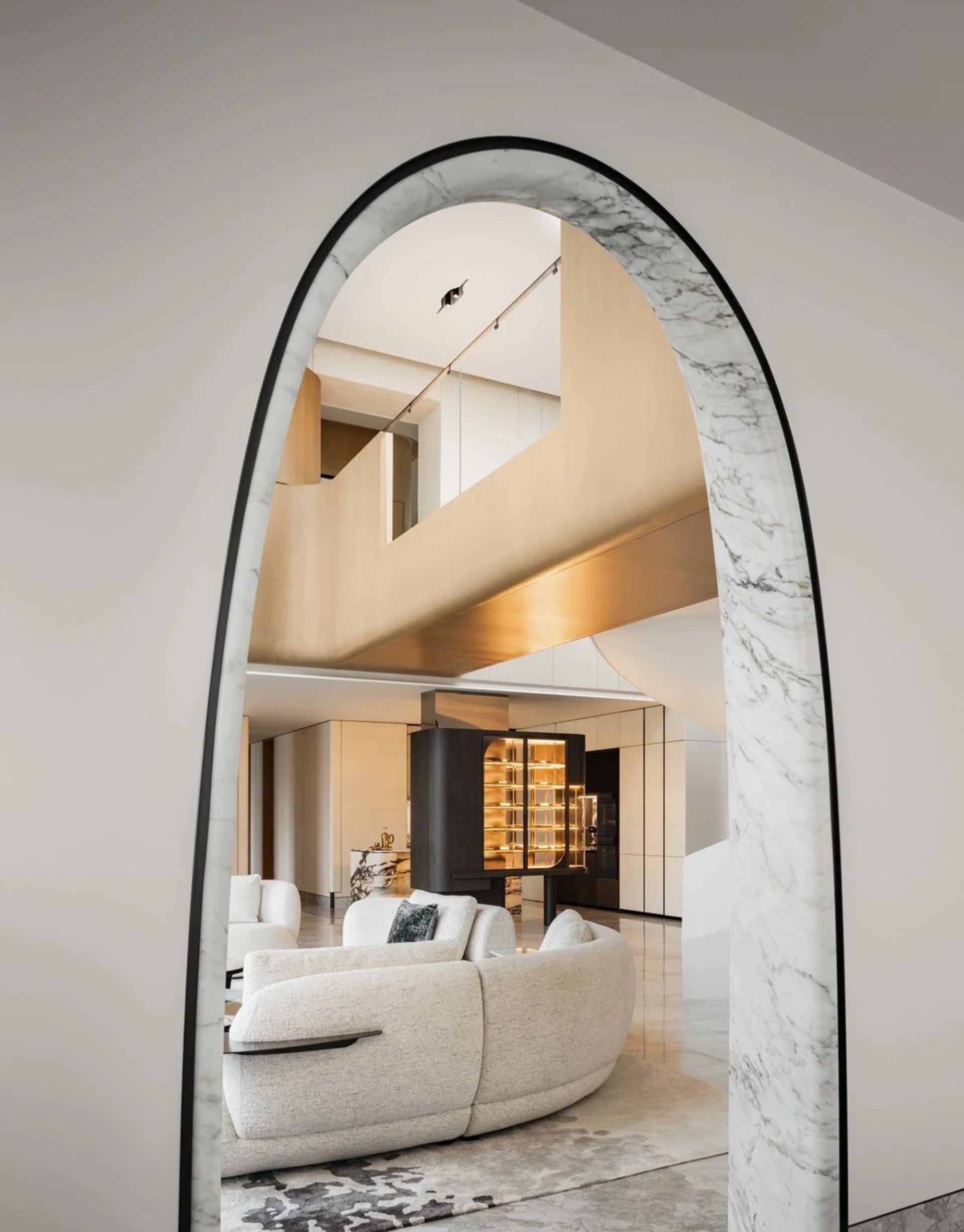 A modern interior design featuring marble materials and contemporary furniture.