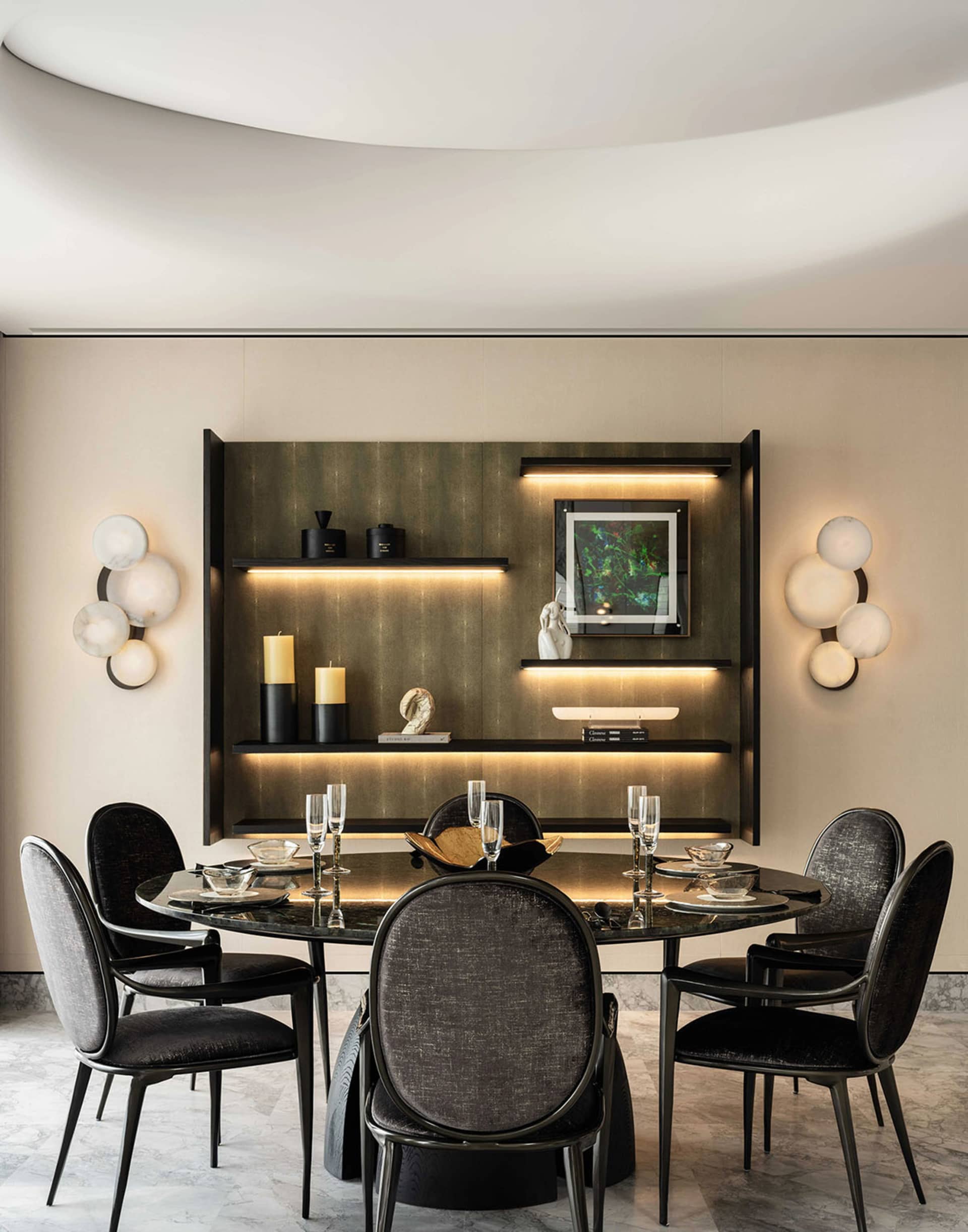 A modern minimalist dining room featuring metallic shelving with ambient lighting and stylish furniture.