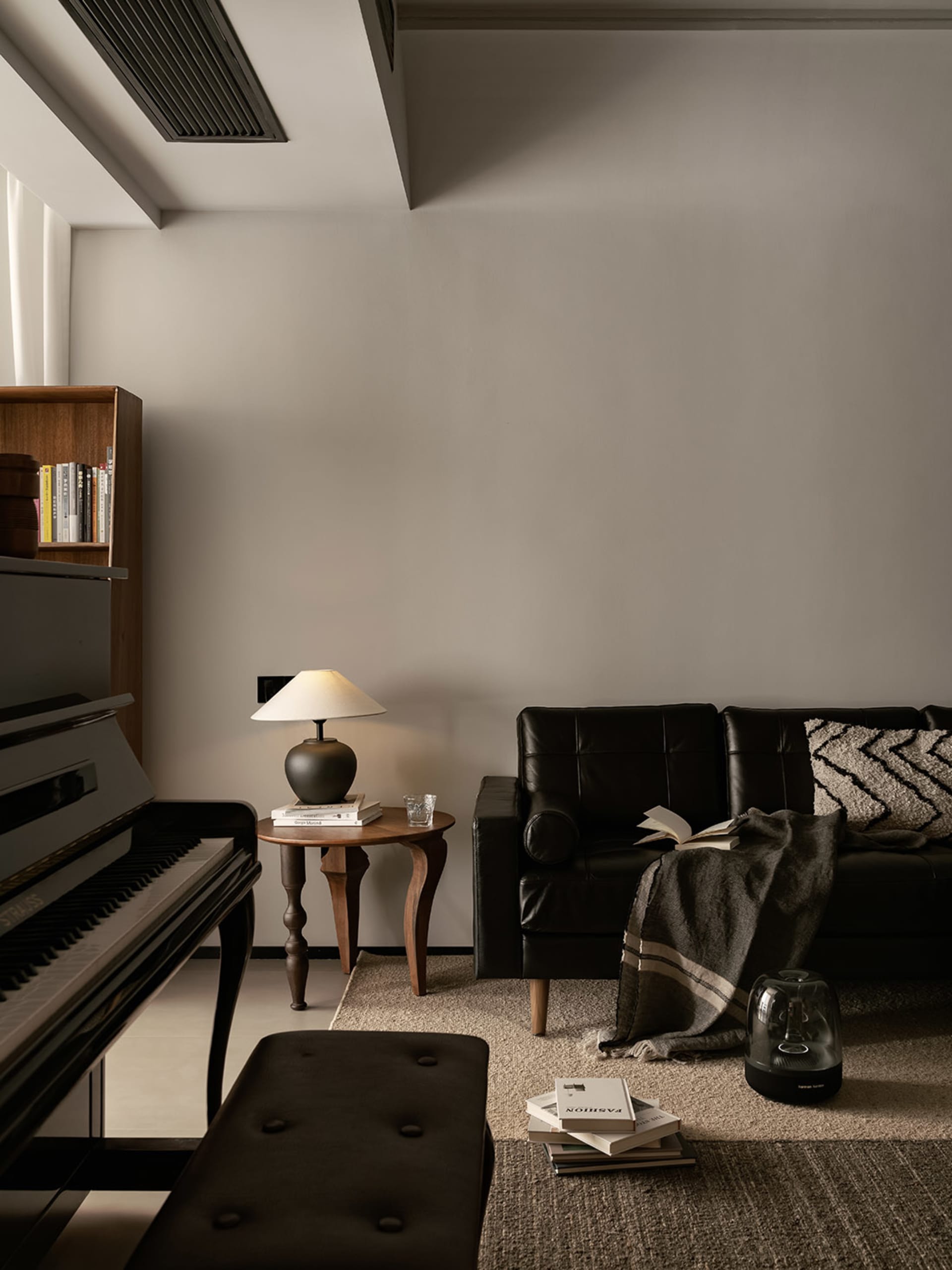 A modern, black profile couch in a living room setting.