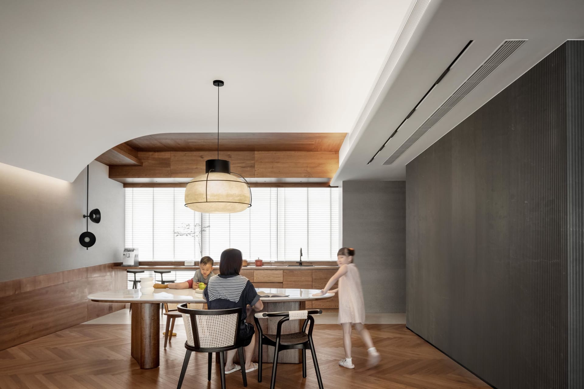 A modern residential kitchen featuring wooden surfaces and marble countertops.