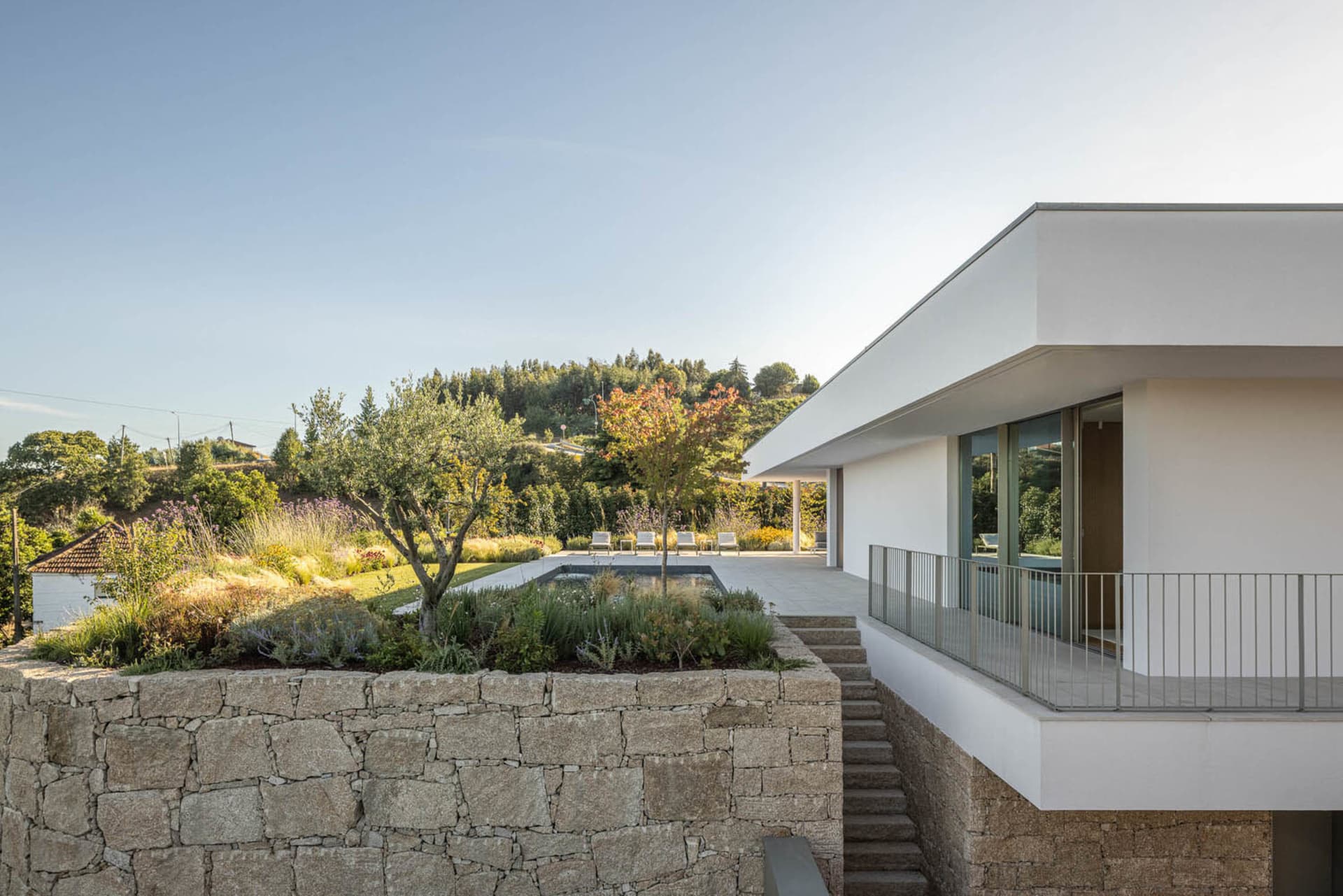 Modern villa featuring stone walls, concrete floor, and glass windows.