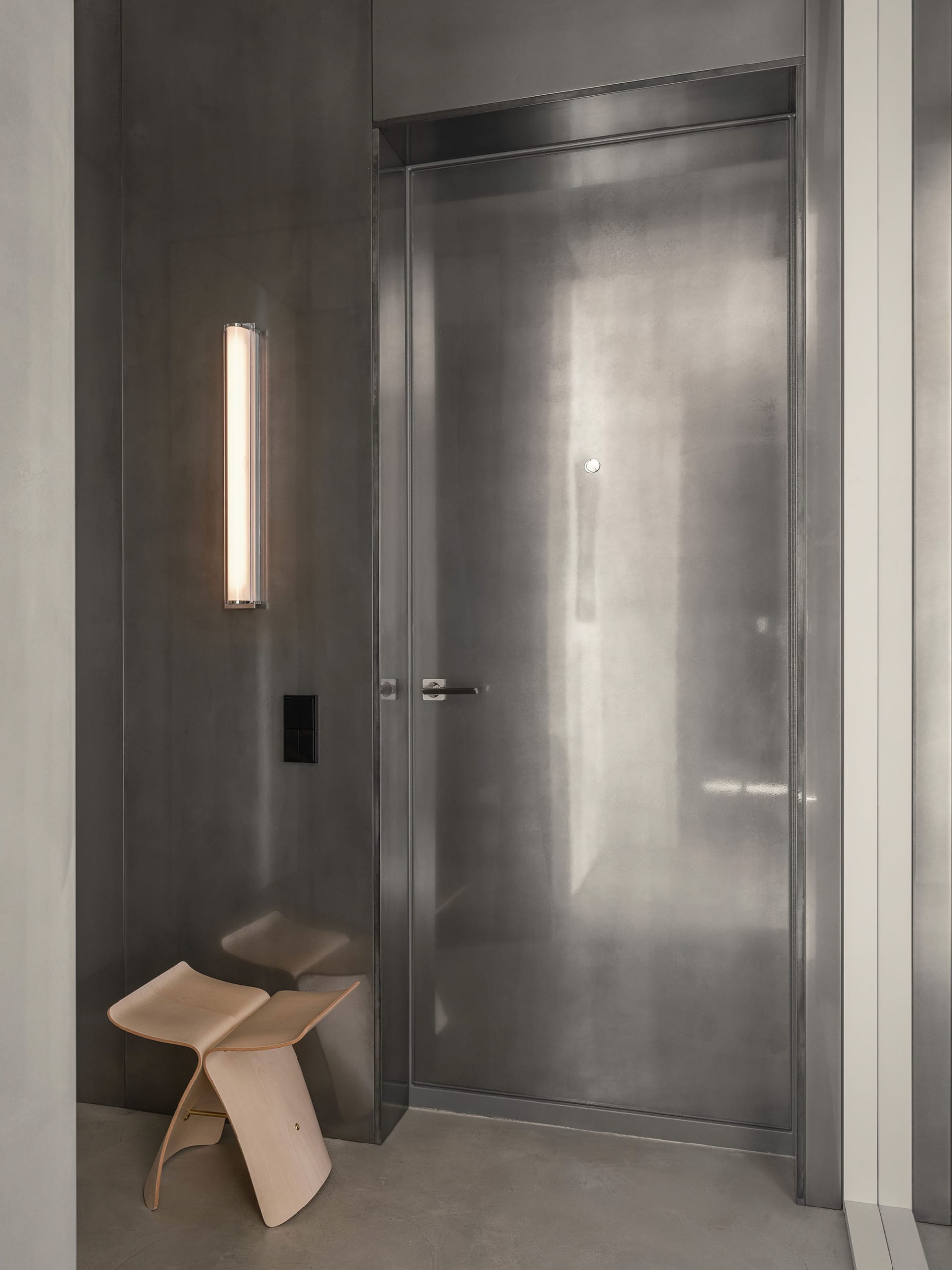 Modern entrance with a metal door and minimalist design