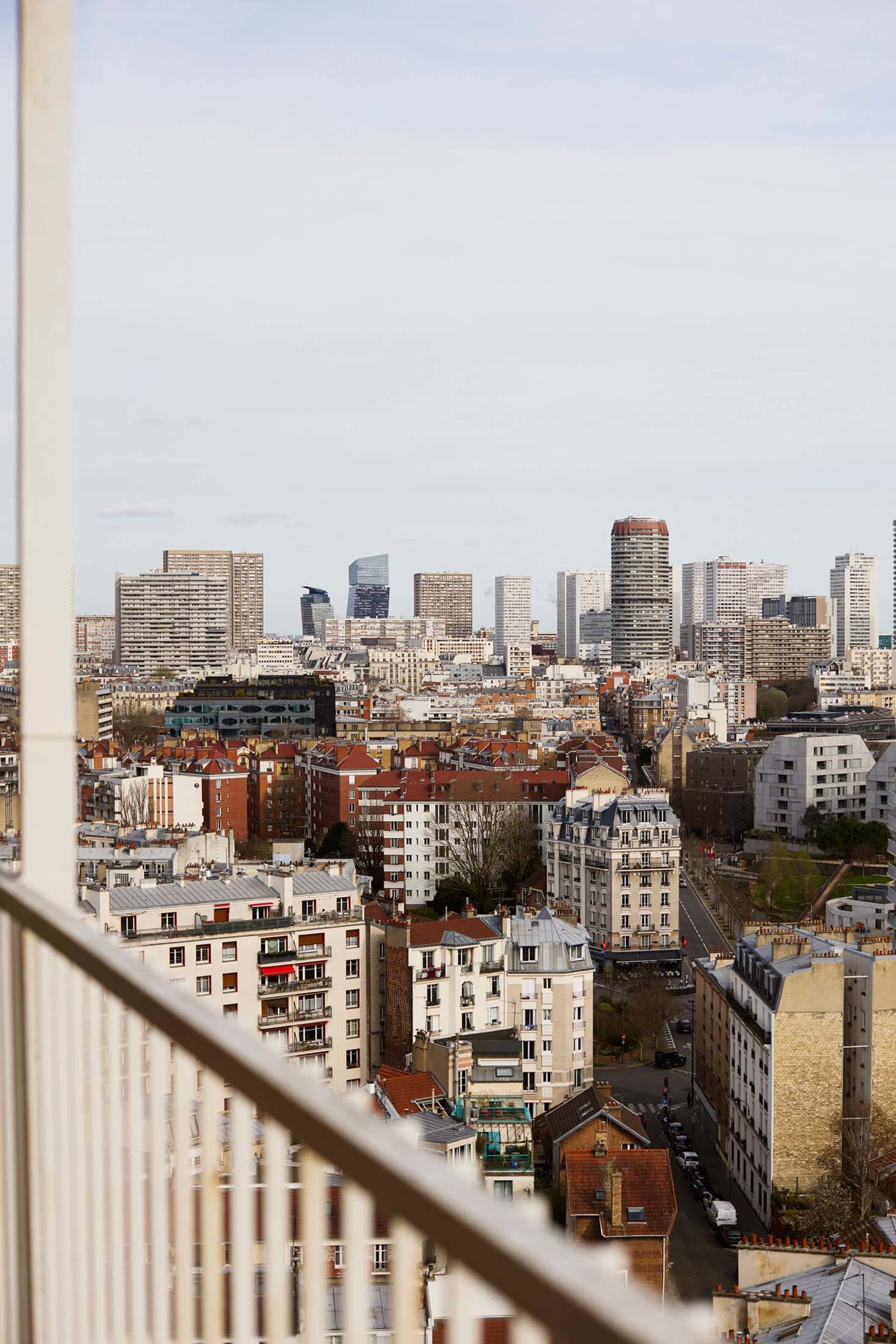 Aerial view of Paris with modern skyscrapers and traditional buildings.