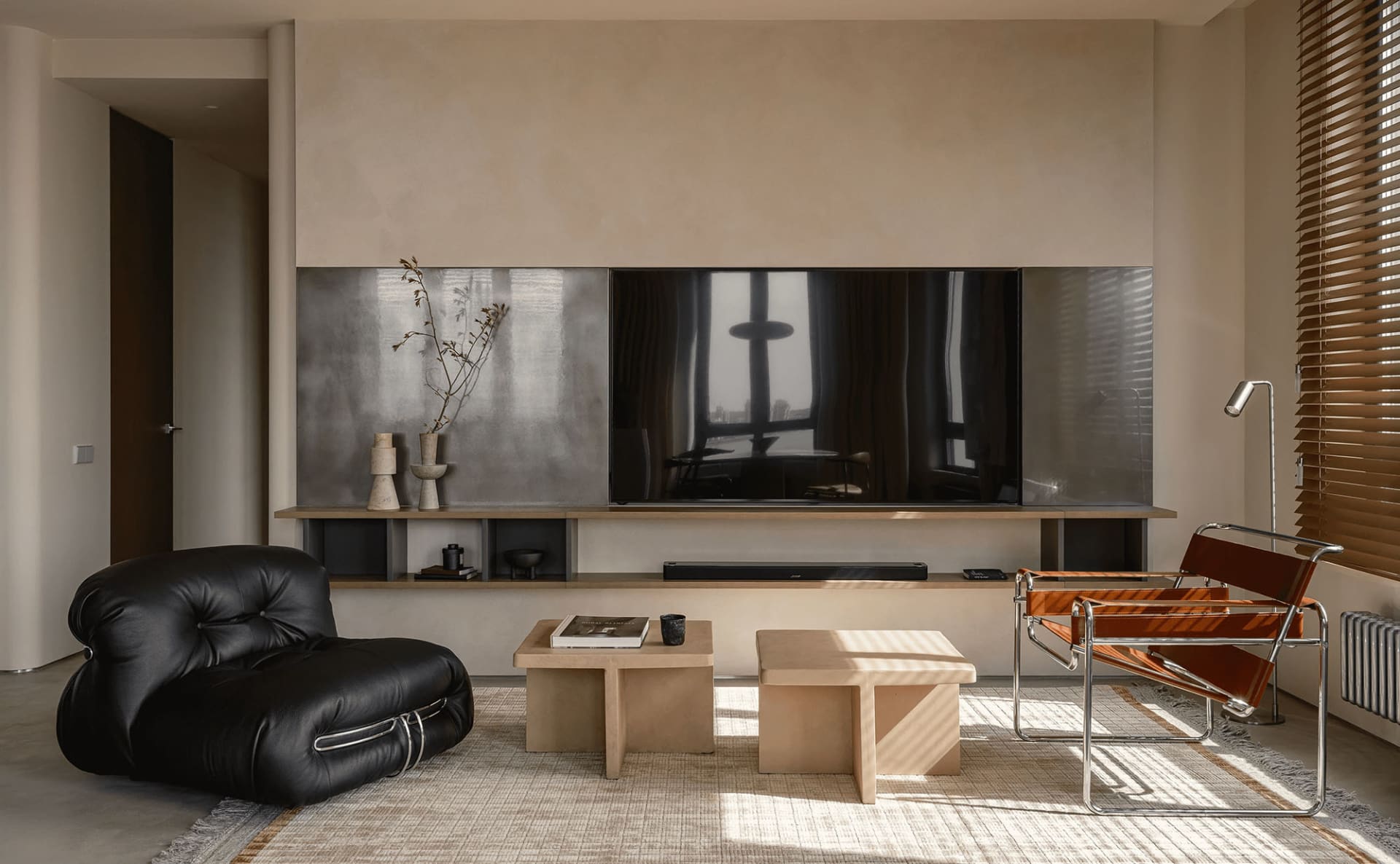 Minimalist living room featuring neutral-toned furniture and decor
