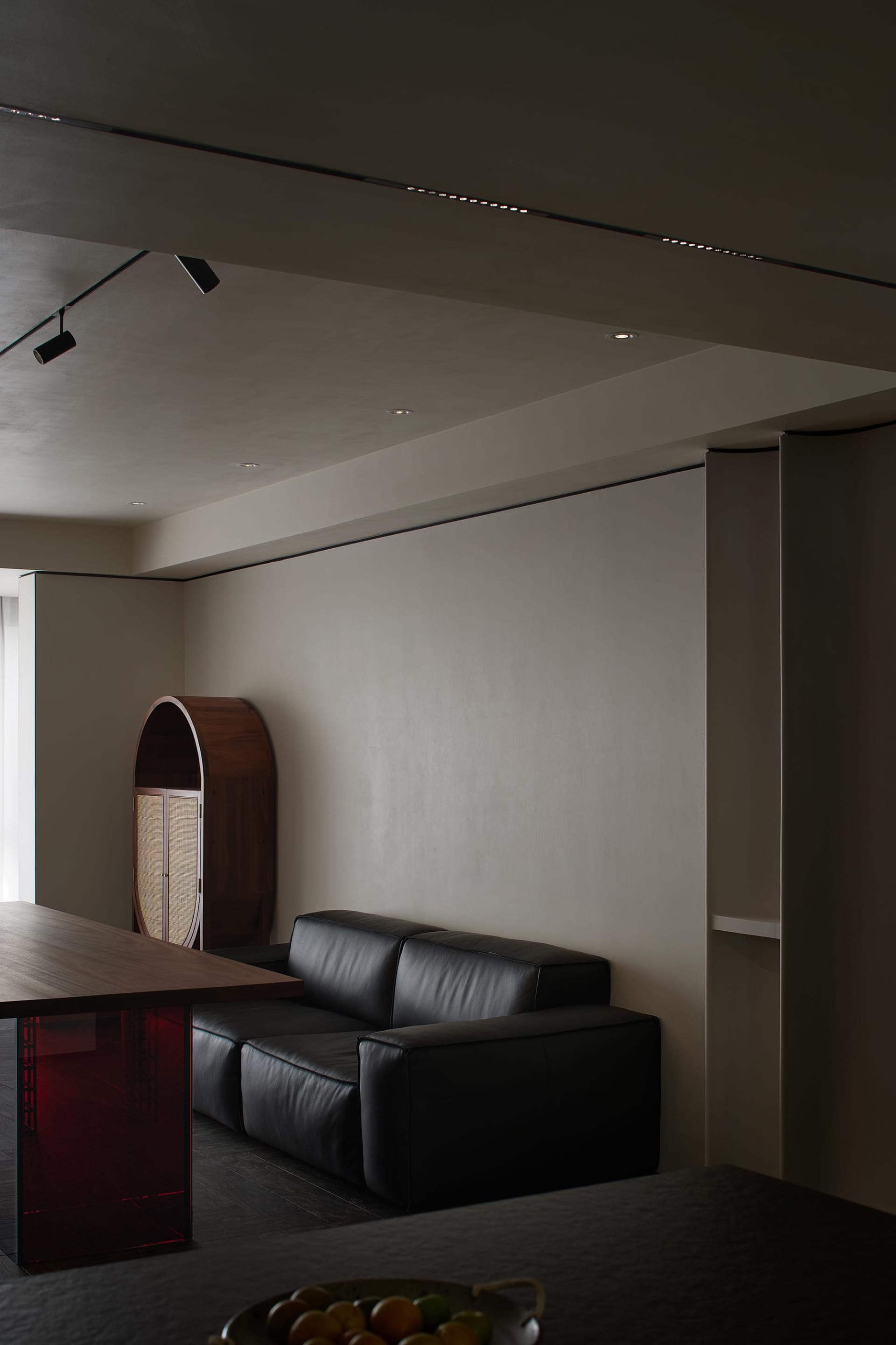 Black leather sofa against a wall in a modern residential interior